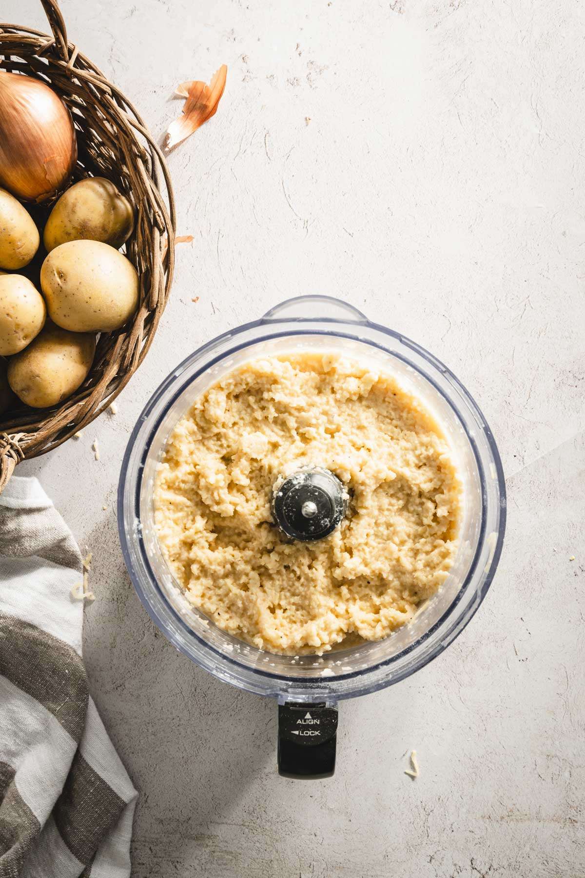 potatoes mixture in a food processor, basket with whole potatoes