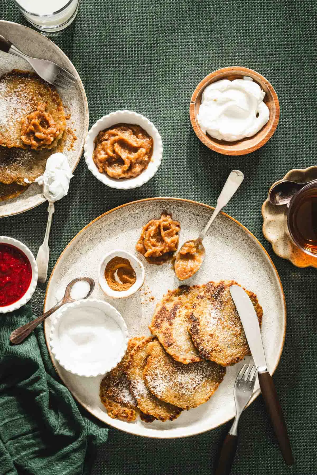 potatoes pancakes styled on a serving platter; small bowls and dishes with various garnishes