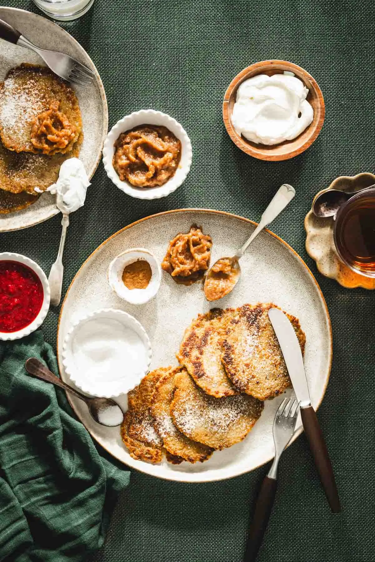 potatoes pancakes styled on a serving platter; small bowls and dishes with various garnishes