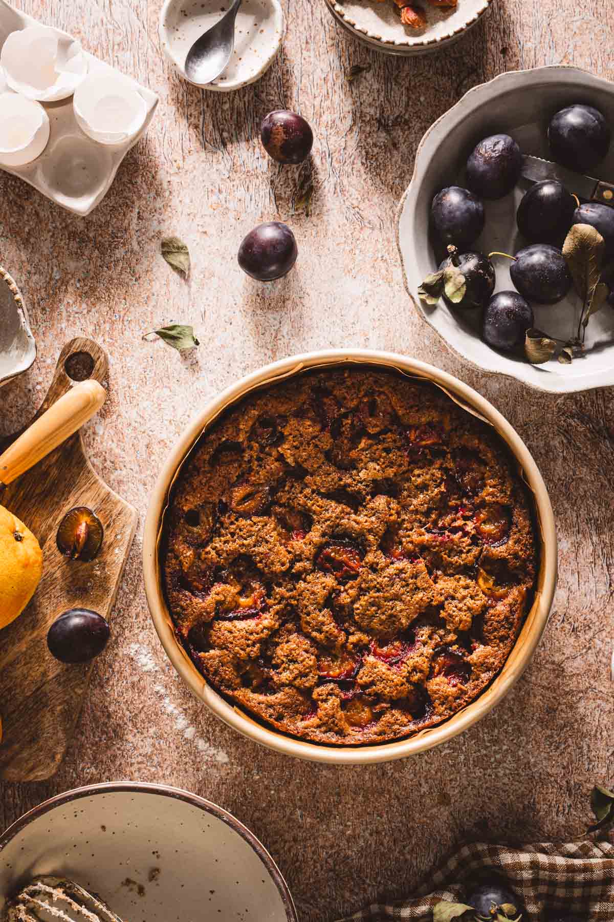 top view of a baked plum cake in the baking pan