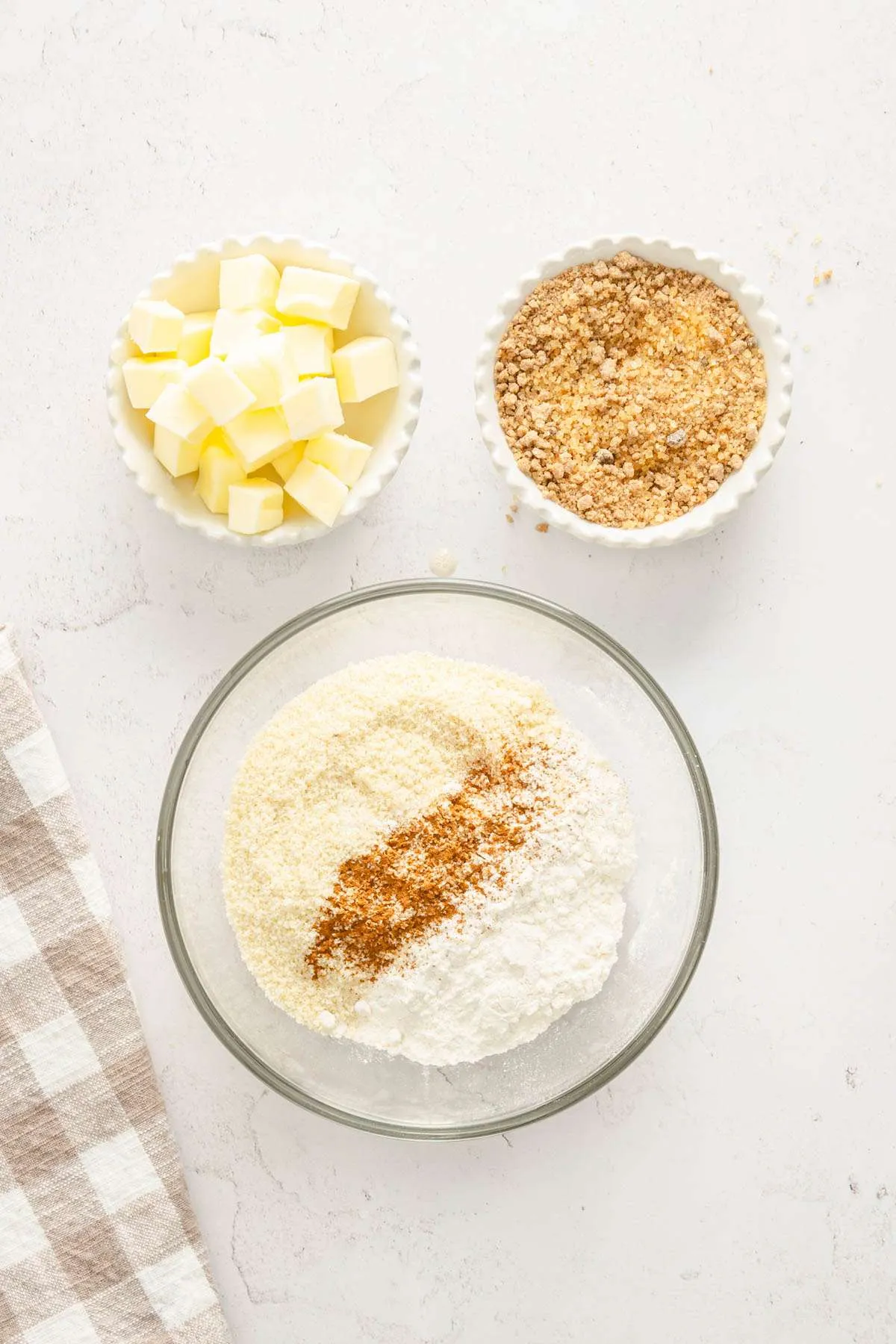 bowl with flour and cinnamon, another dish with brown sugar and cubed butter