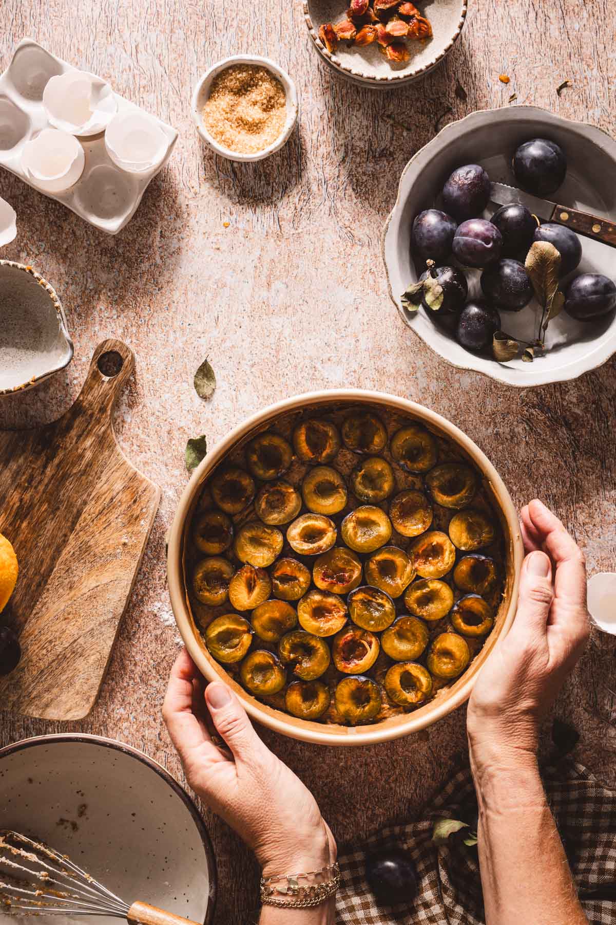 hands in frame holding the pan with the cake