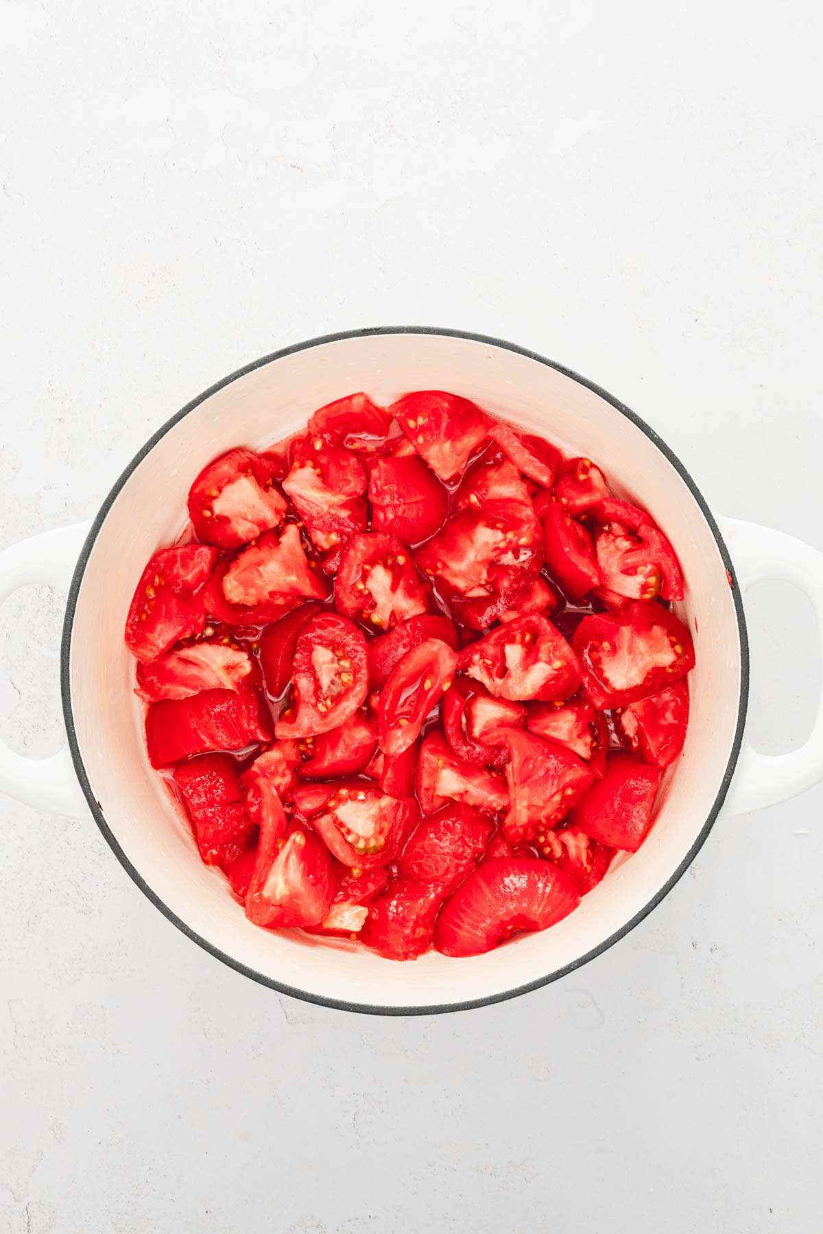 large stock pot with cut up tomatoes