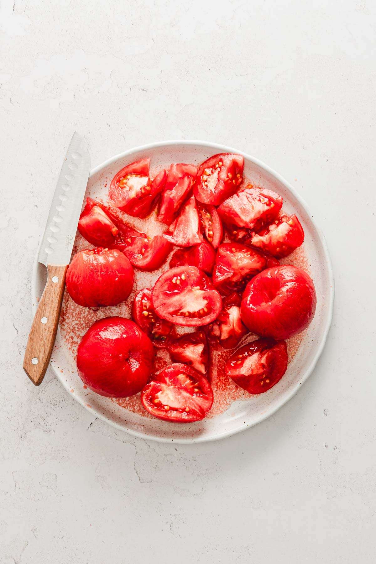 large plate with peeled and roughly chopped tomatoes