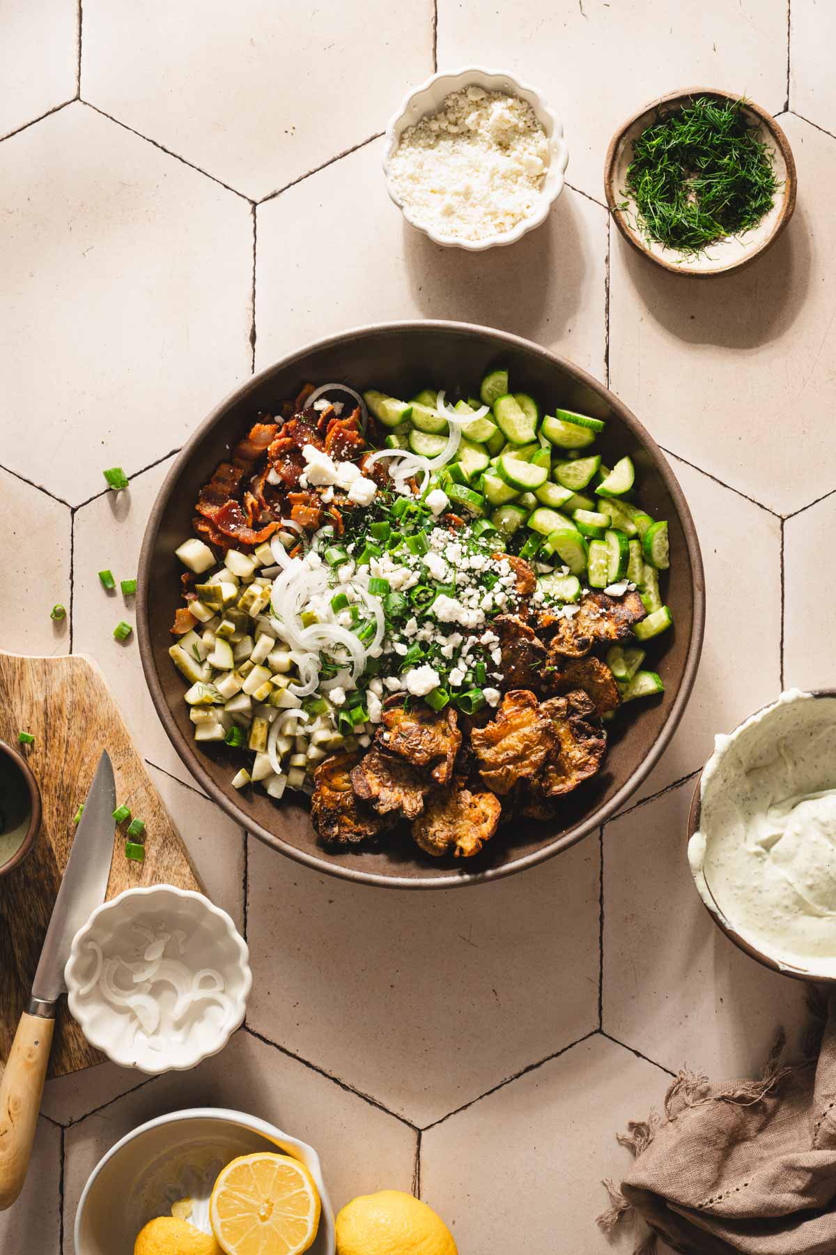 large serving bowl with the salad before mixing, cutting board