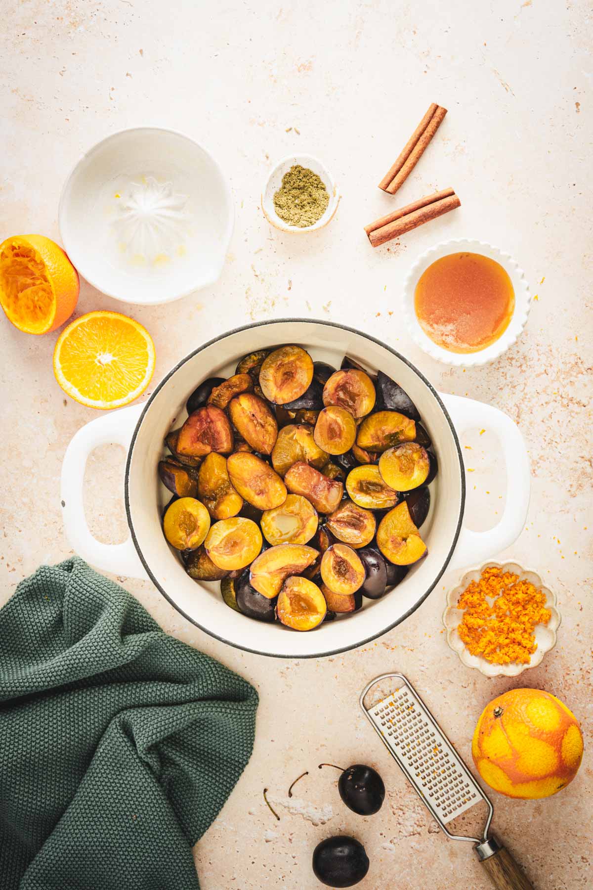 large pan with cut up plums, added orange juice