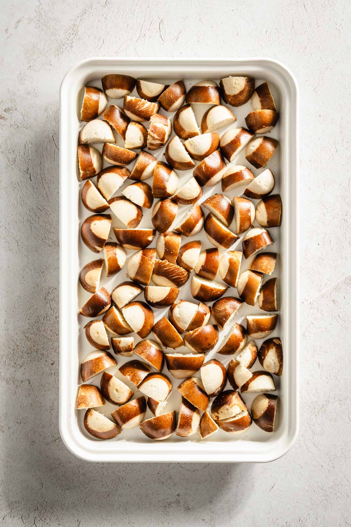 Pretzel mini buns on a baking sheet