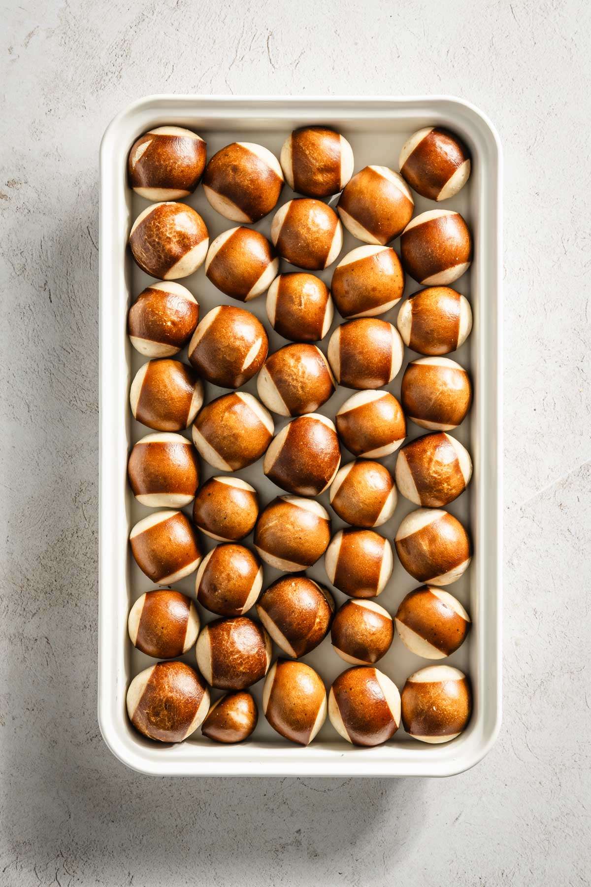 Pretzel mini buns on a baking sheet