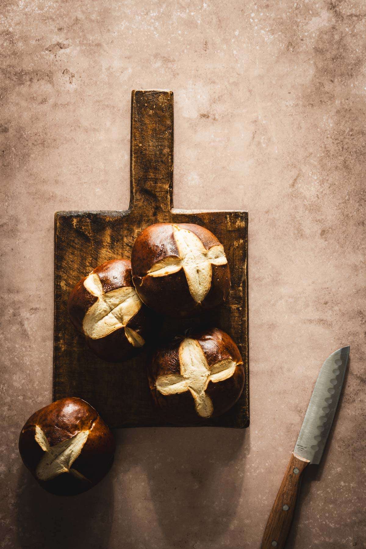 pretzel buns on a cutting board