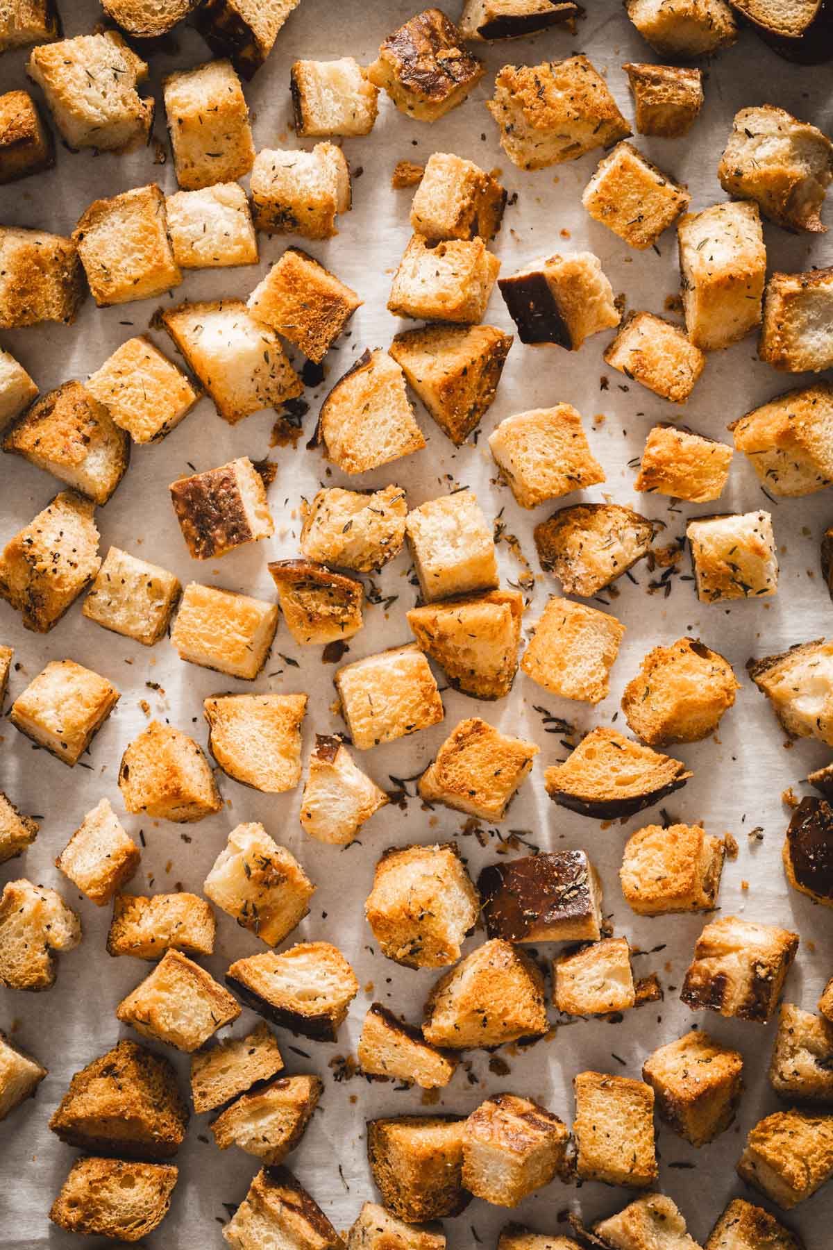 pretzel bun croutons on a baking sheet,