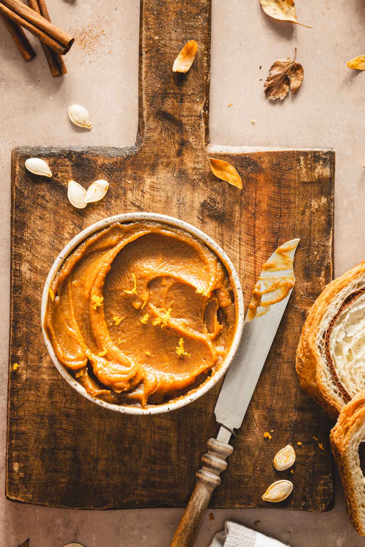 pumpkin butter in a serving bowl on a wooden tray