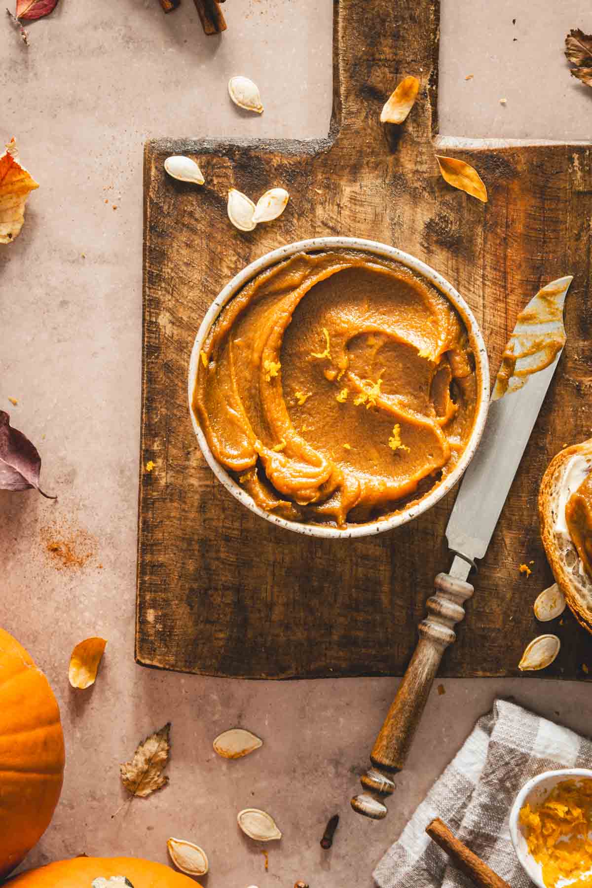 pumpkin butter in a serving bowl on a wooden tray, close up