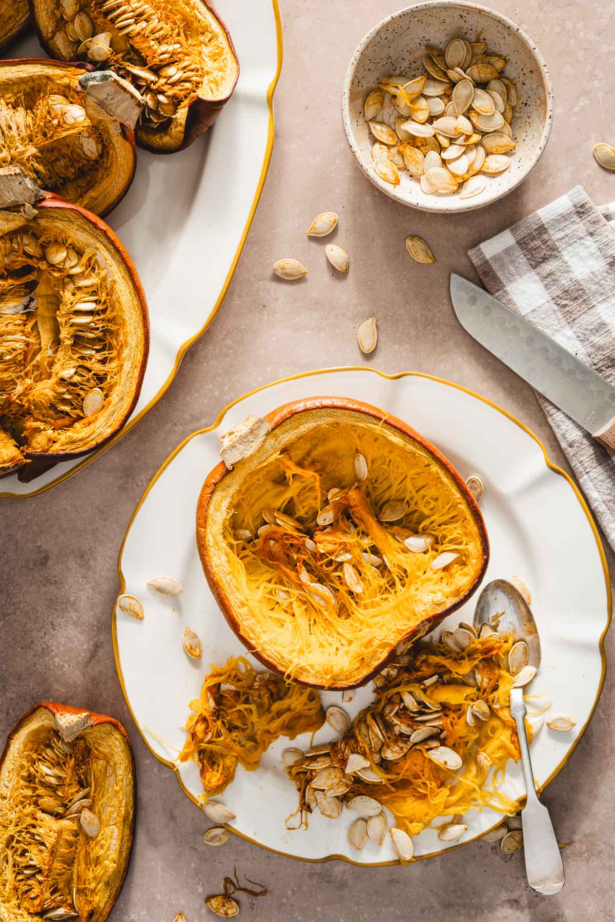 cooked pumpkin on a plate, bowl with seeds