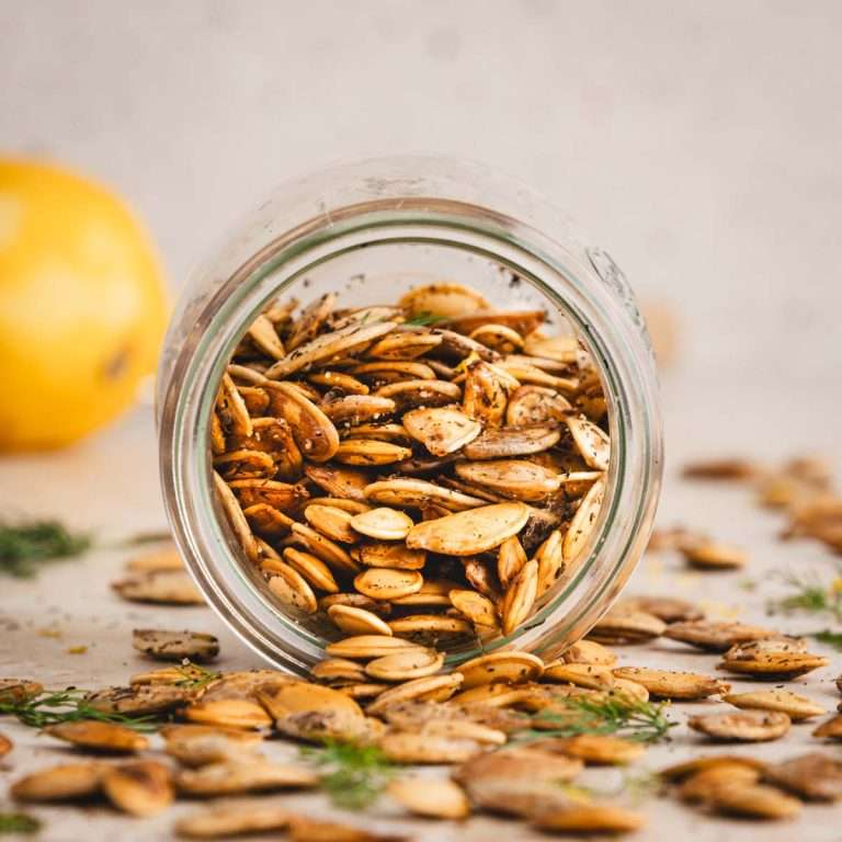 roasted pumpkin seeds in a glass jar, front view