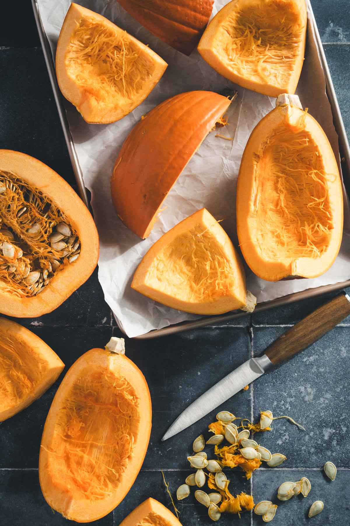 cut up pumpkins on a baking sheet