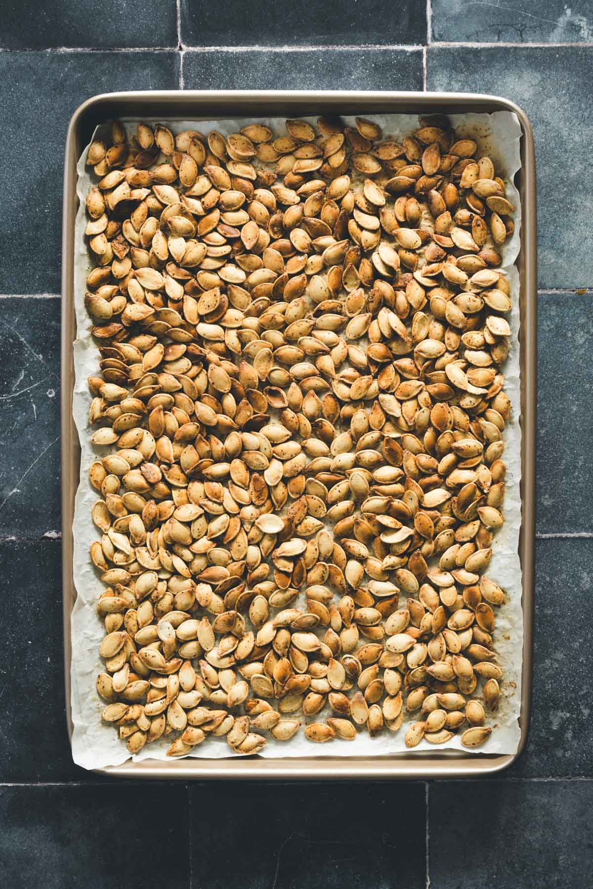 smoked pumpkin seeds on a baking sheet