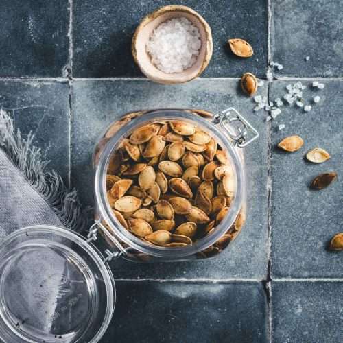 pumpkin seeds in a glass jar, top view