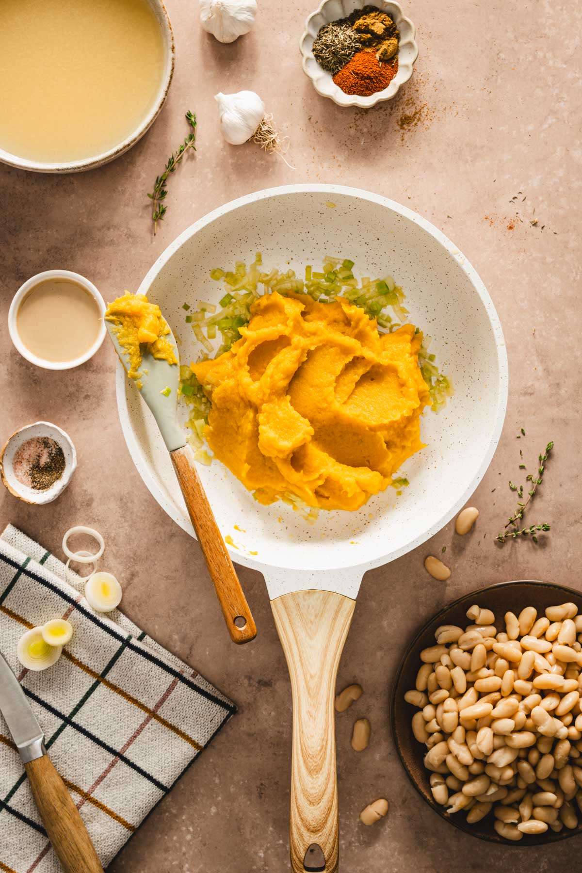 pumpkin puree added to the skillet with cooked leeks