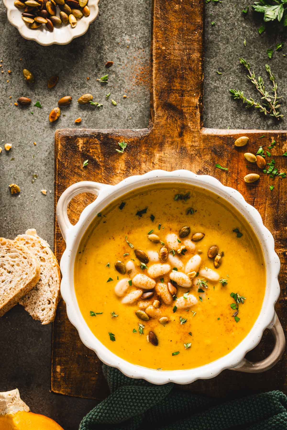 bowl with pumpkin soup on a wooden tray