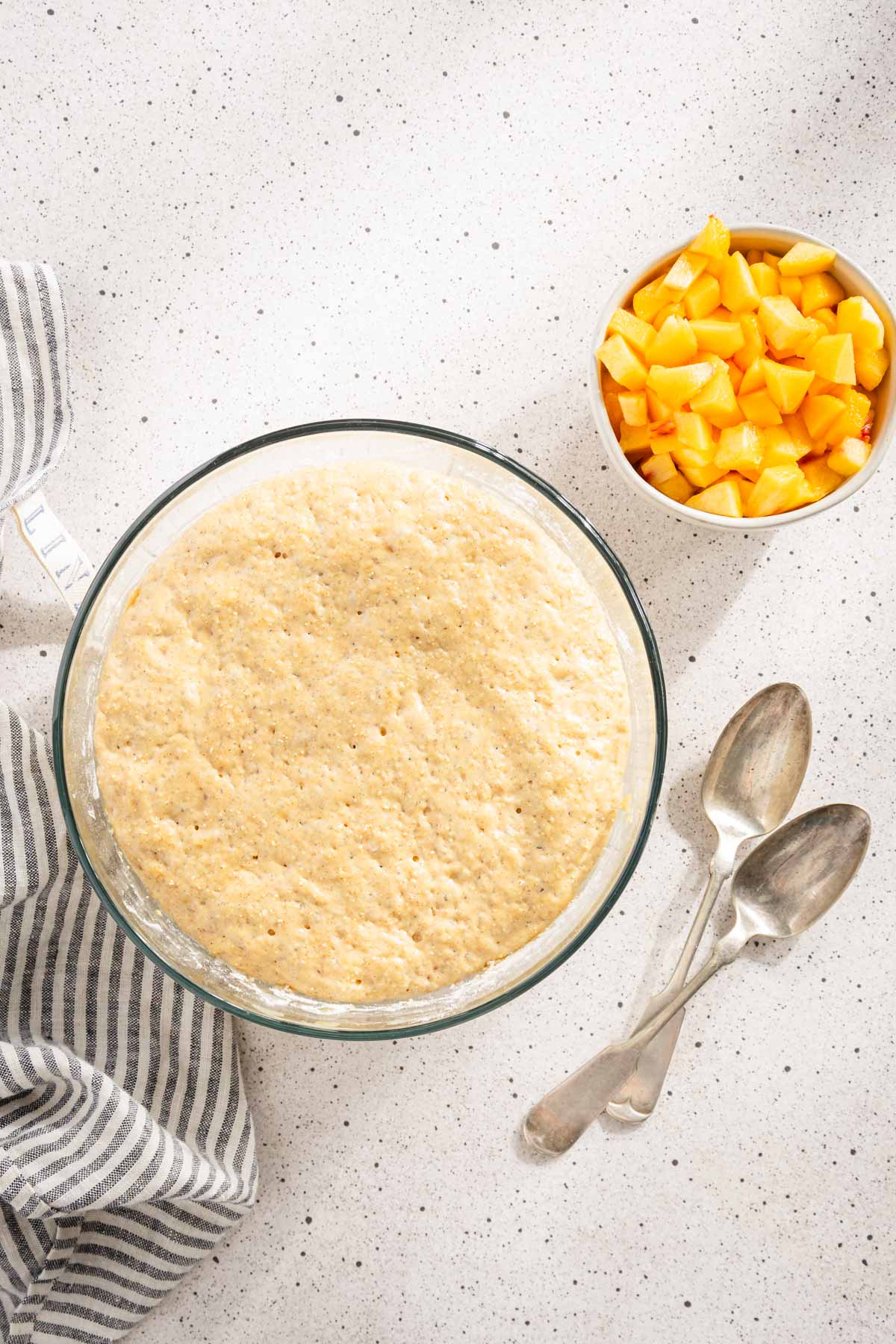 dough for racuchy, bowl with cut up peaches