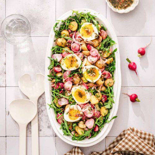platter with the salad, napkin, fresh radishes