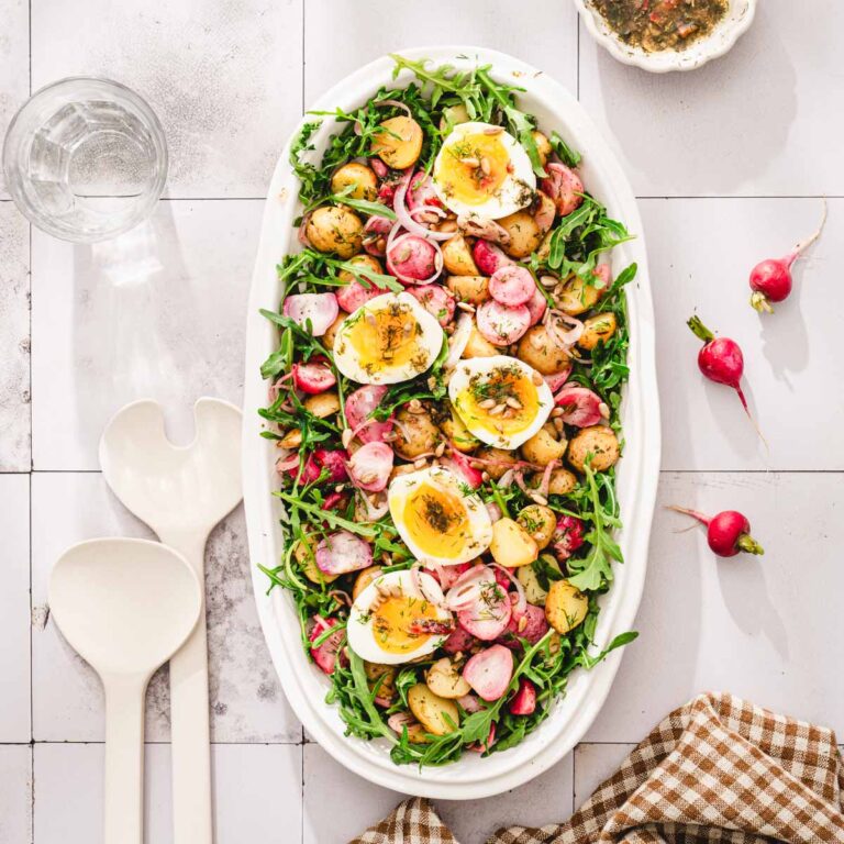 platter with the salad, napkin, fresh radishes