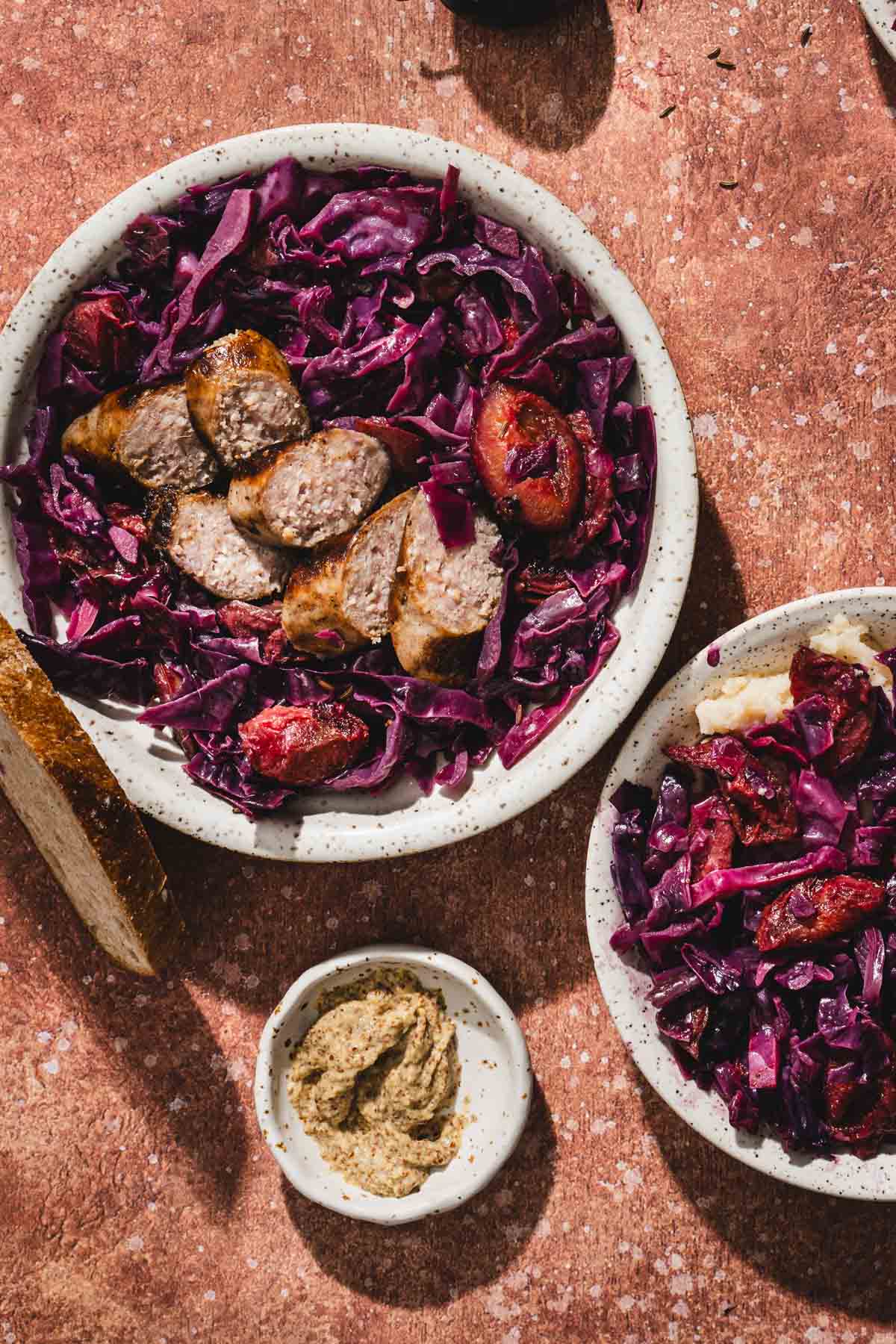 serving bowl with red cabbage dish and sausage