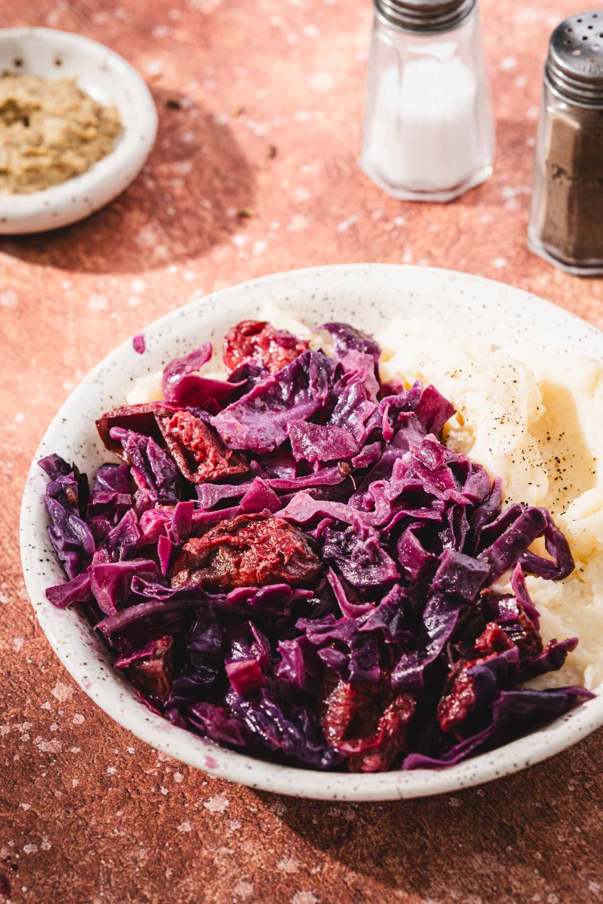 side view of a bowl with cabbage dish and mashed potatoes