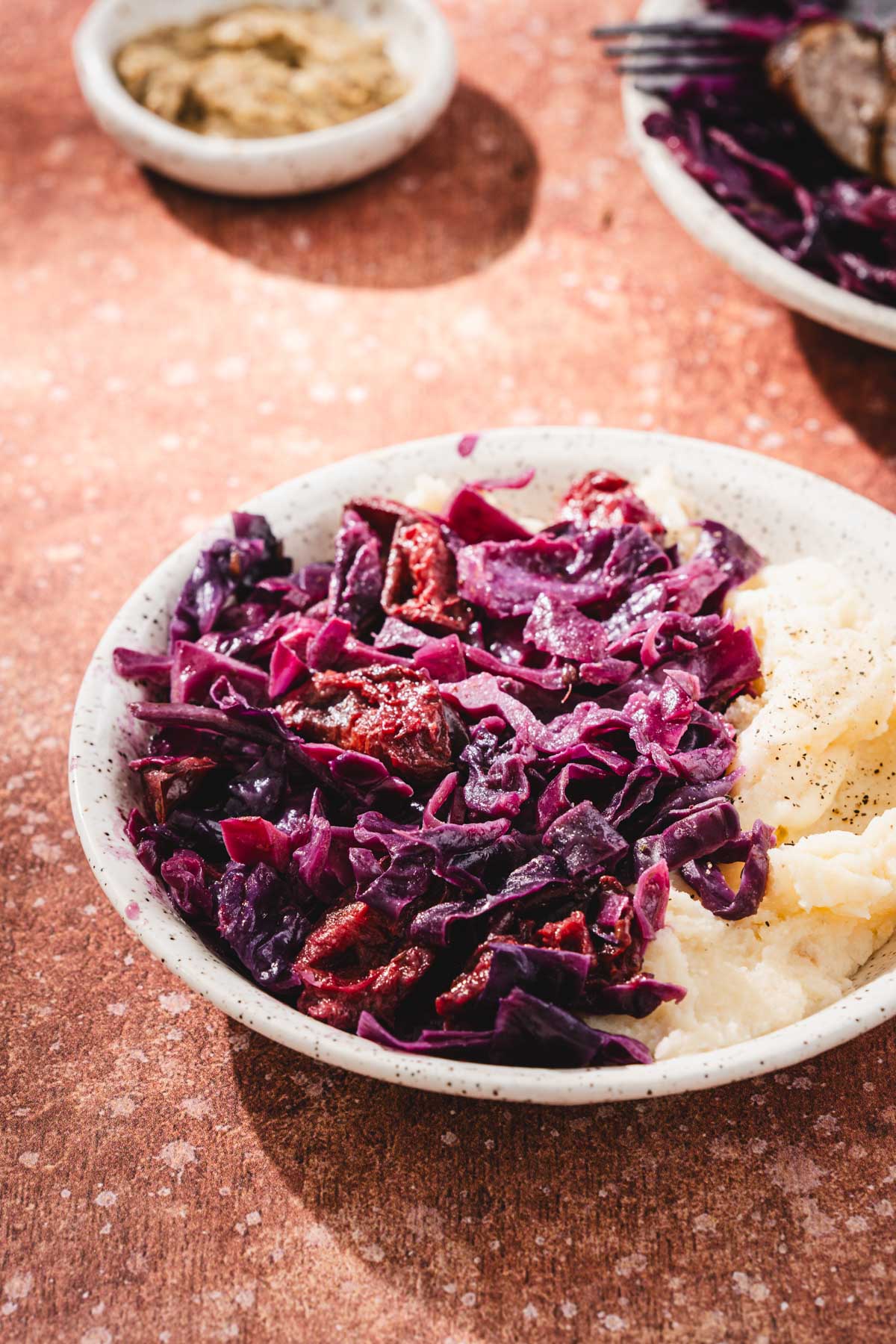 side view of a bowl with cabbage dish and mashed potatoes
