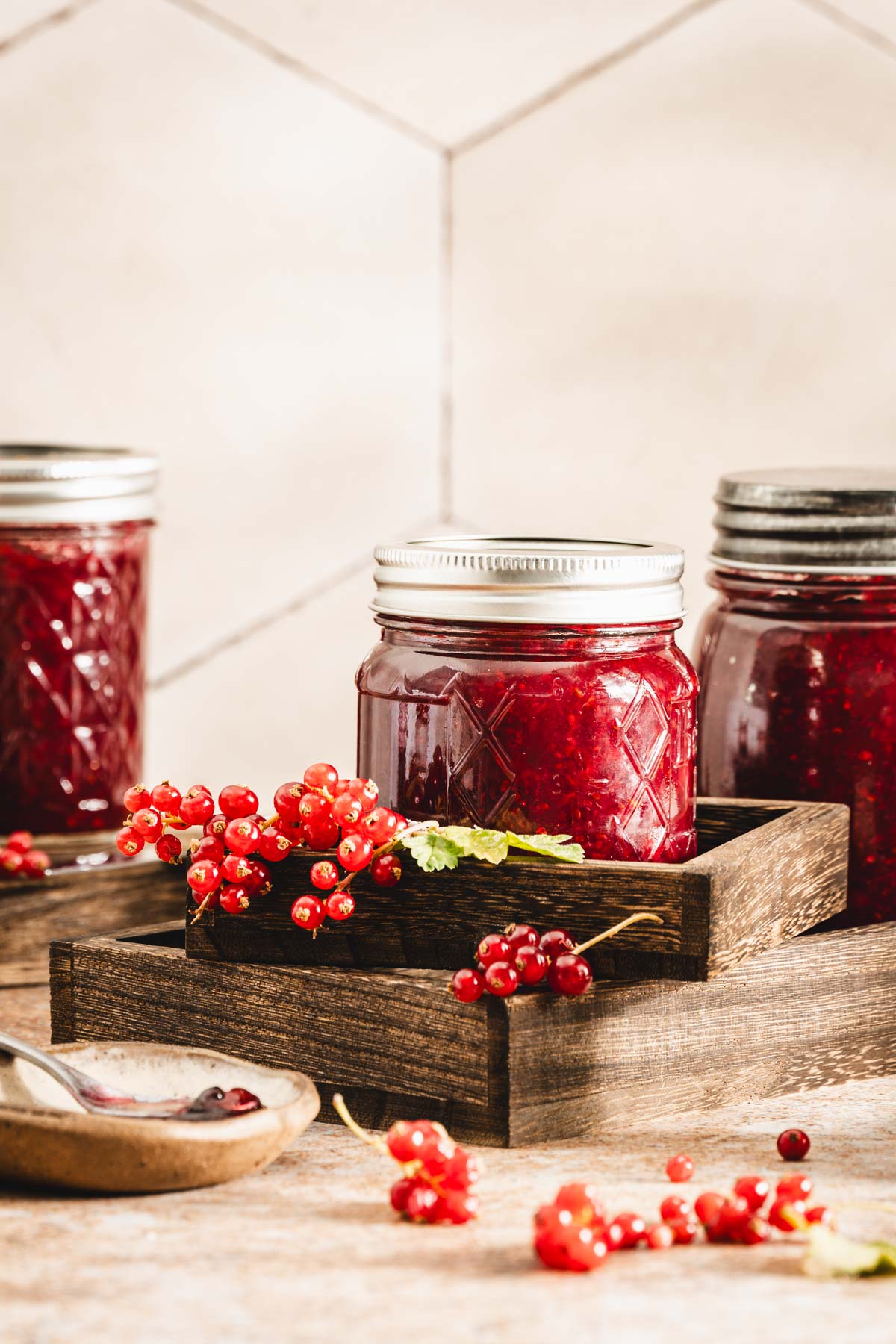 jars with jam, placed on top of wooden trays
