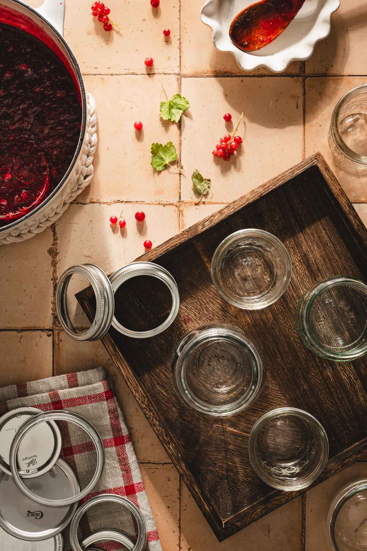 various empty jars on a wooden tray