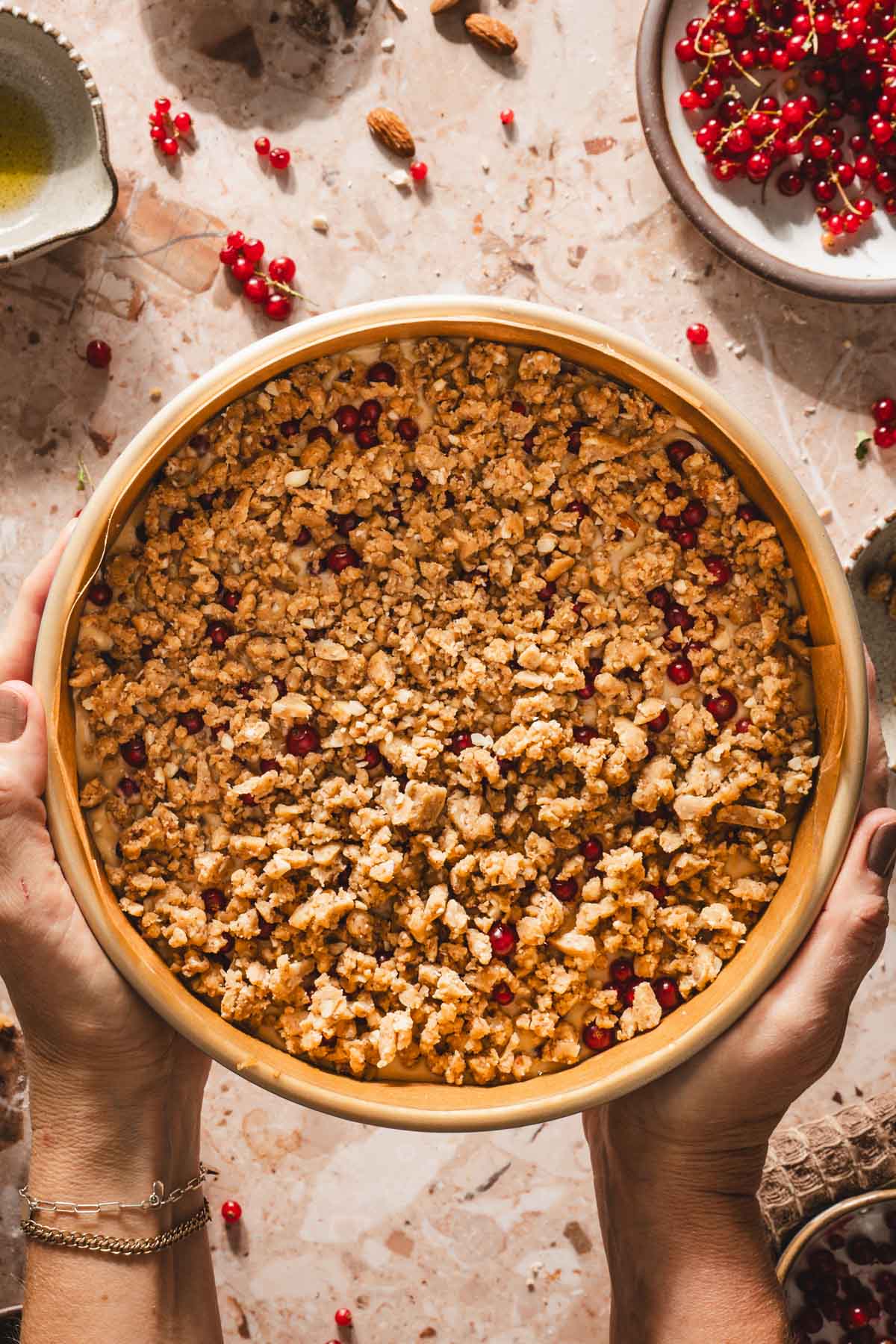 hands in frame holding the pan with cake