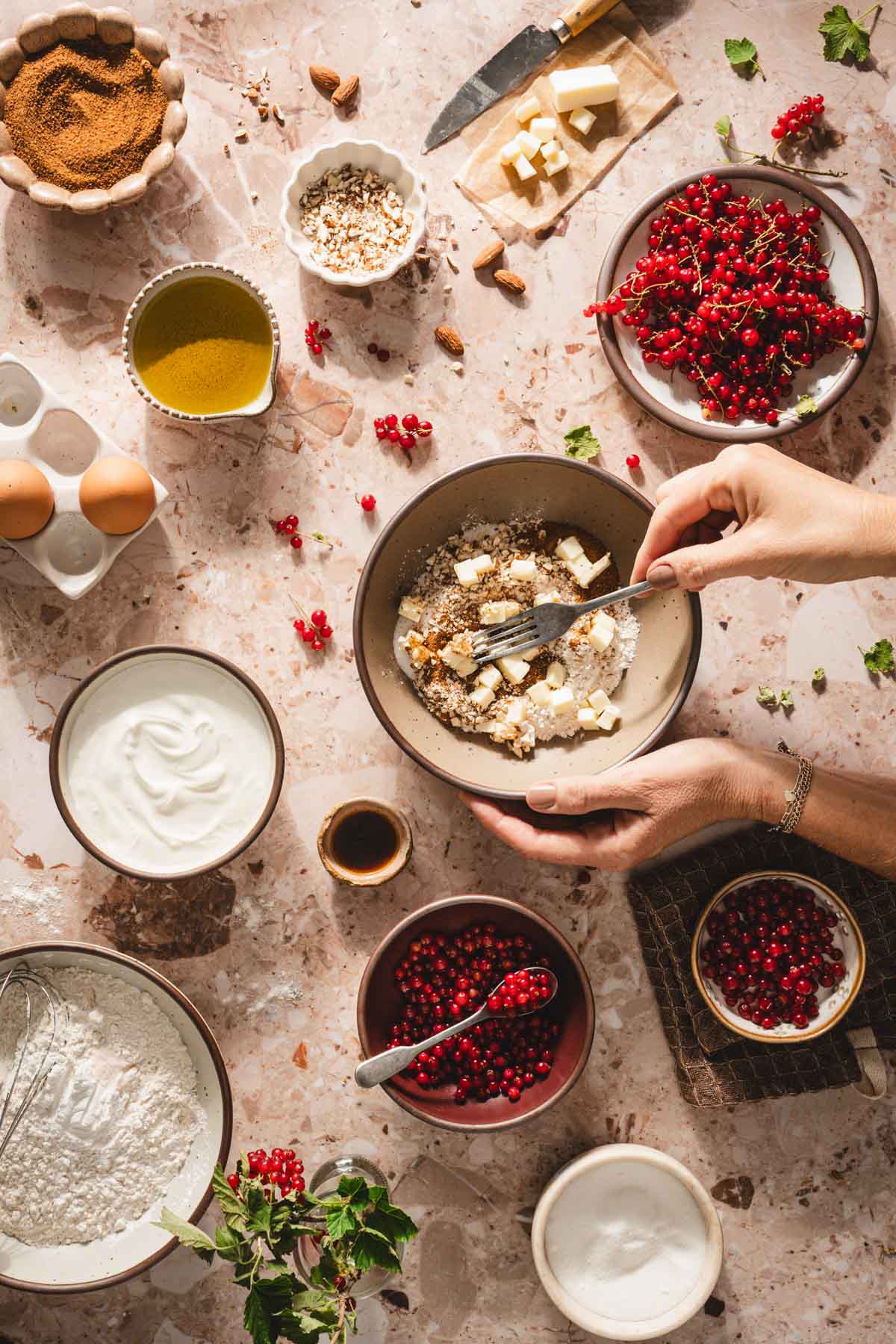 hands in frame crushing butter with a fork for the crumble