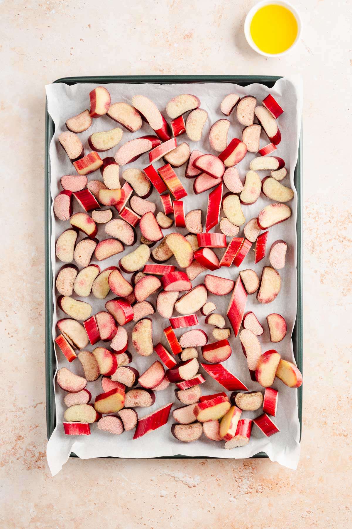 cut up rhubarb in a baking sheet, dish with oil