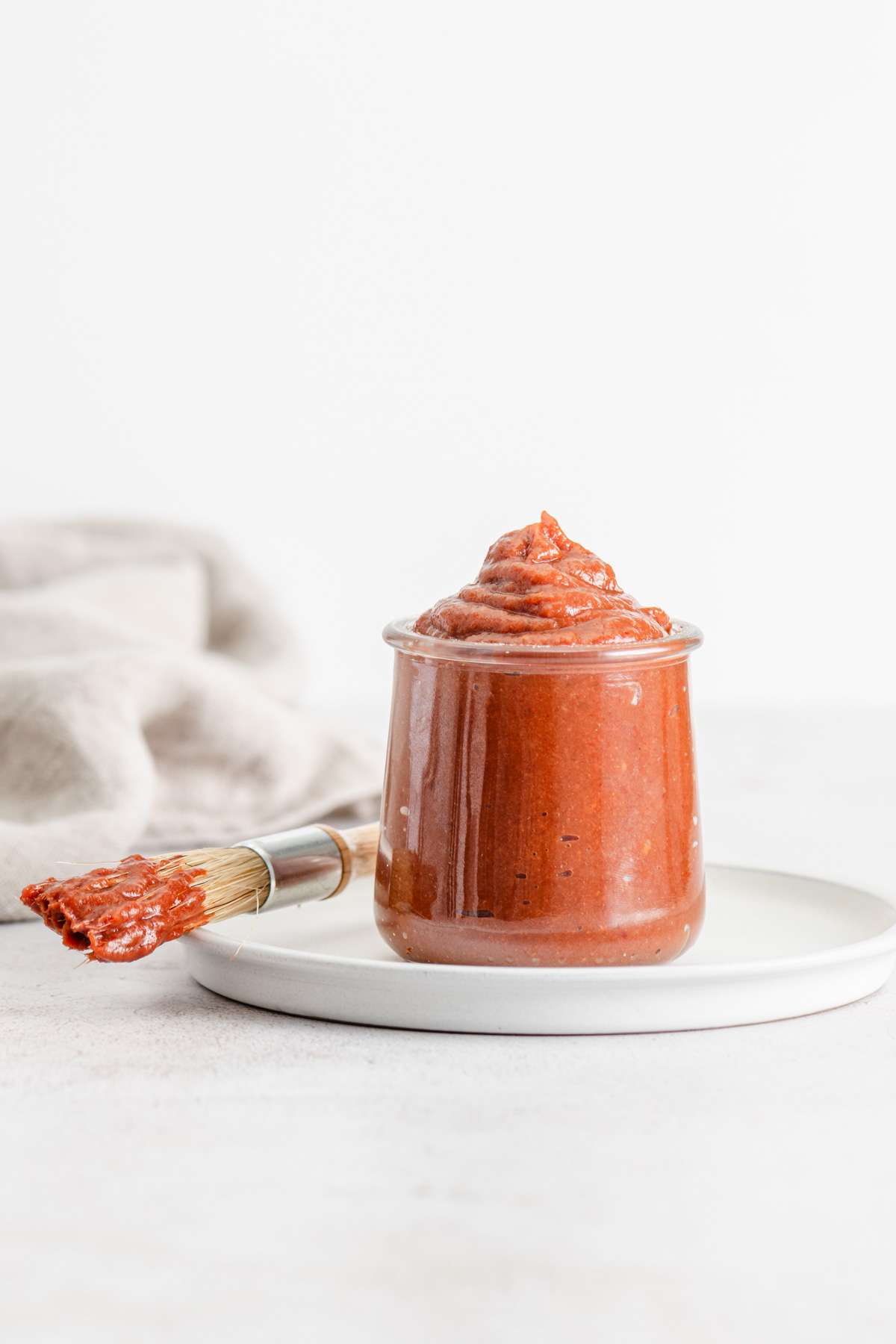 rhubarb BBQ sauce in a glass jar, front view