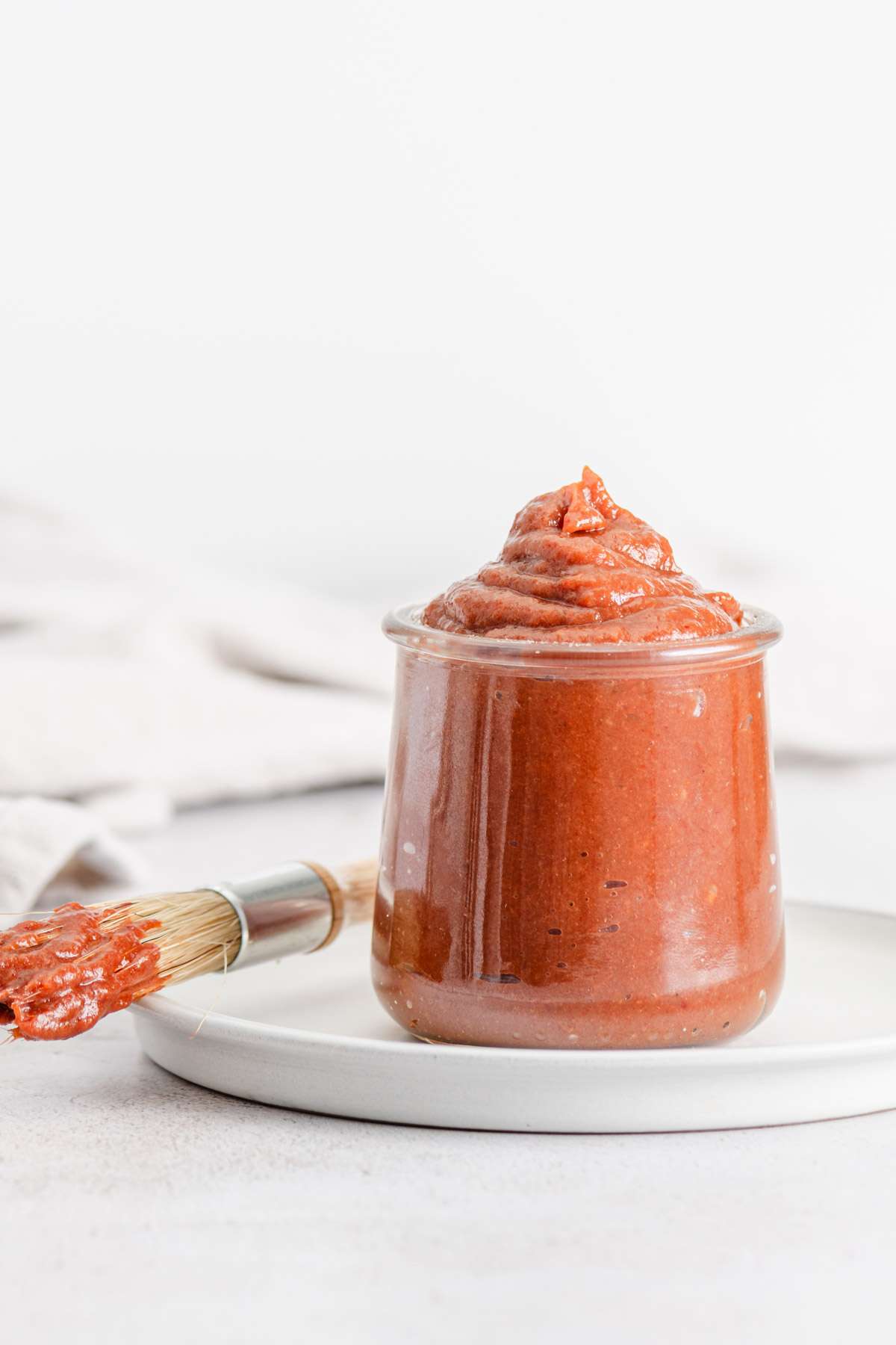 rhubarb BBQ sauce in a glass jar, front view , close up