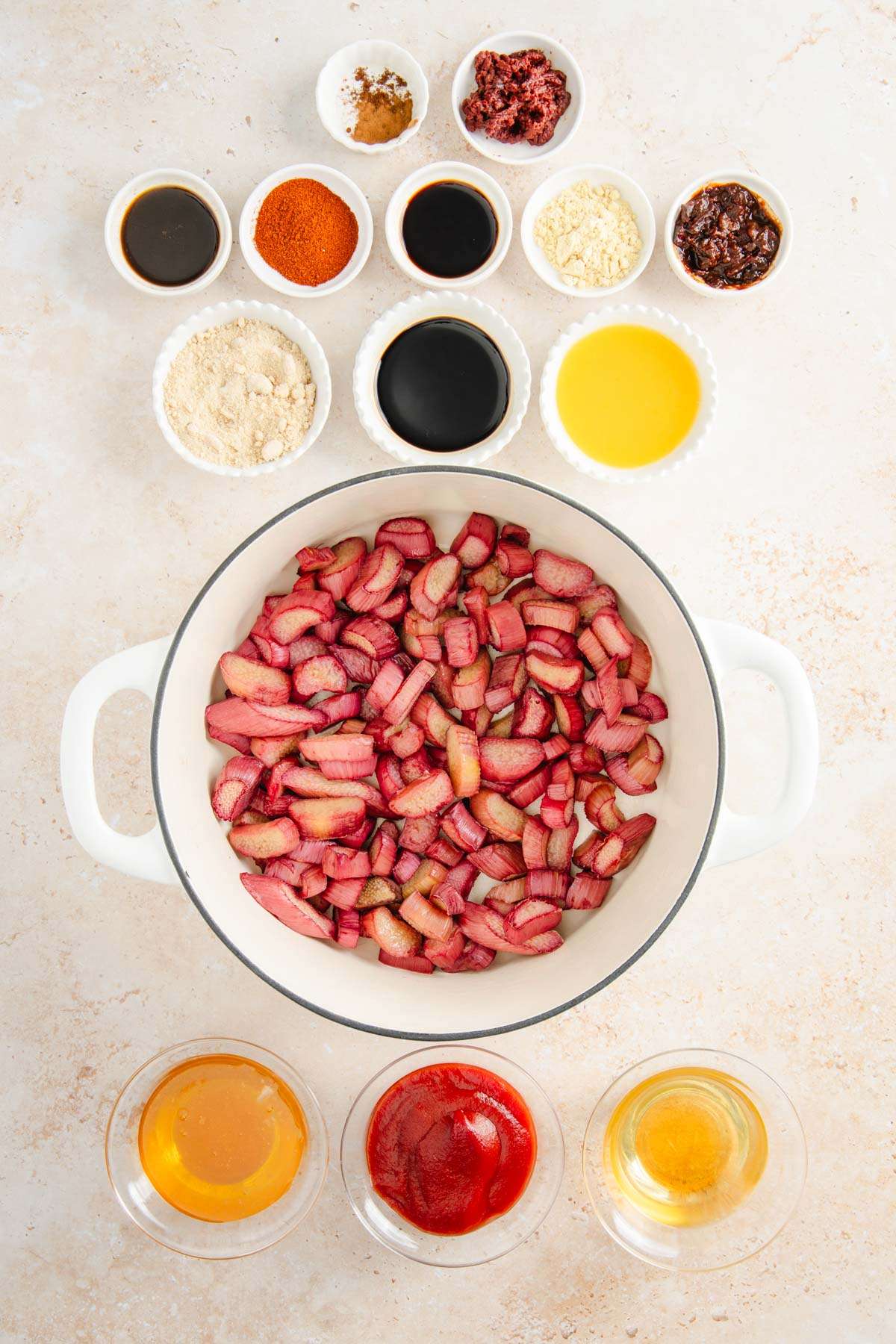 roasted rhubarb in a stock pot, other ingredients in small dishes arranged around