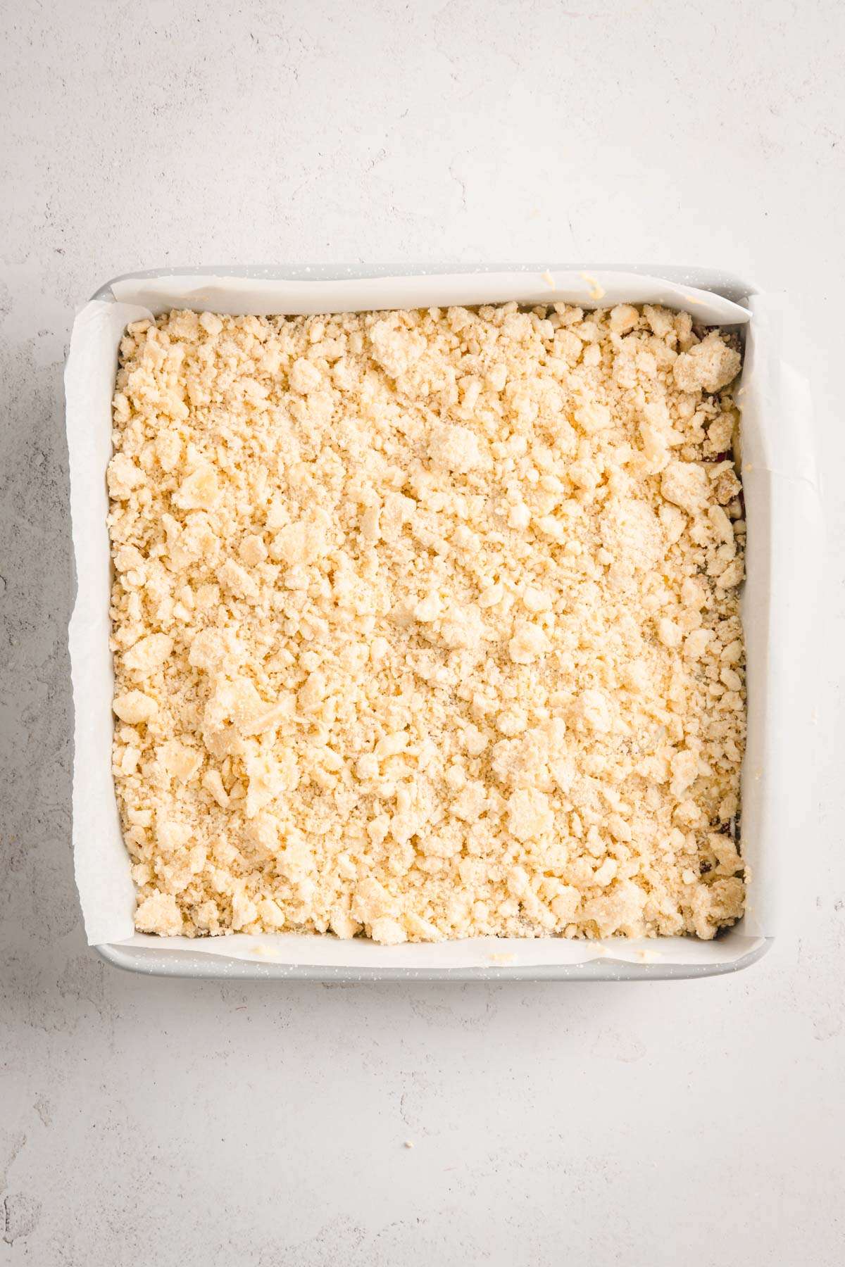 rhubarb cake in a baking dish ready for baking