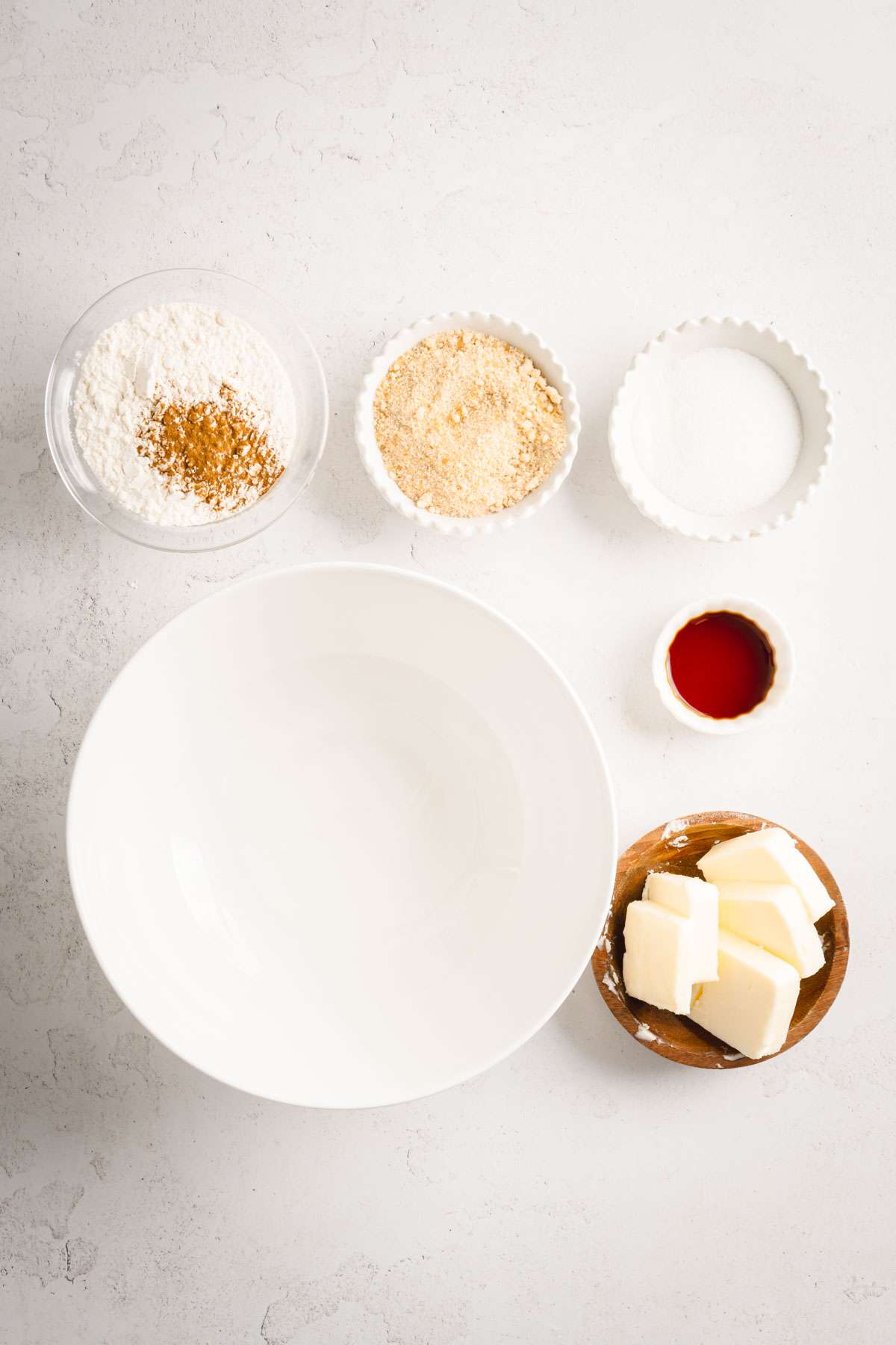 large empty bowl, small bowls with ingredients for the crumble topping