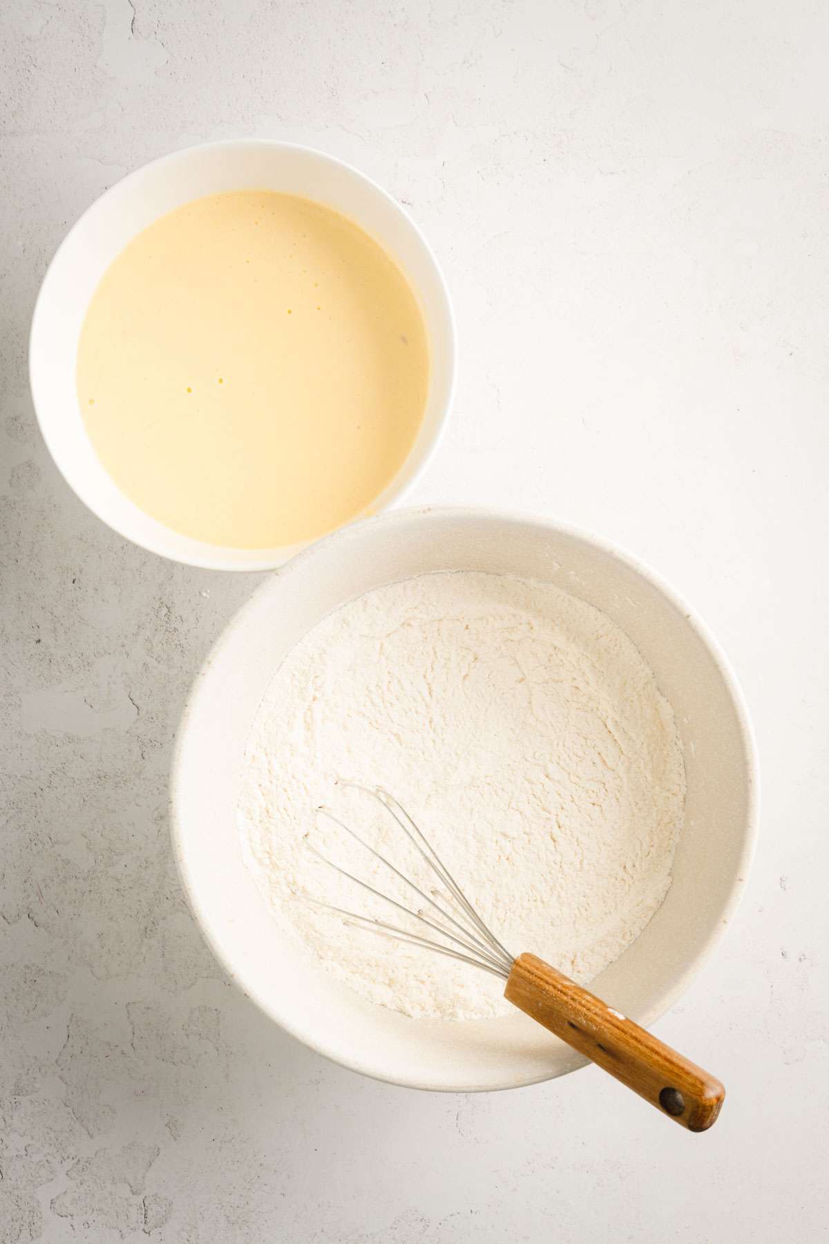 two bowls, one with flour mix, one with wet ingredients