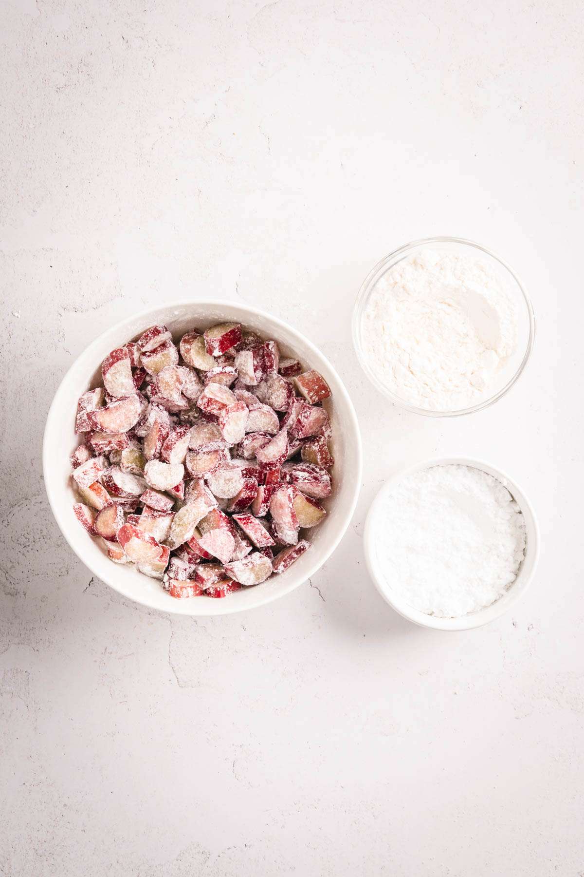 bowl with cut up rhubarb mixed in with flour and sugar