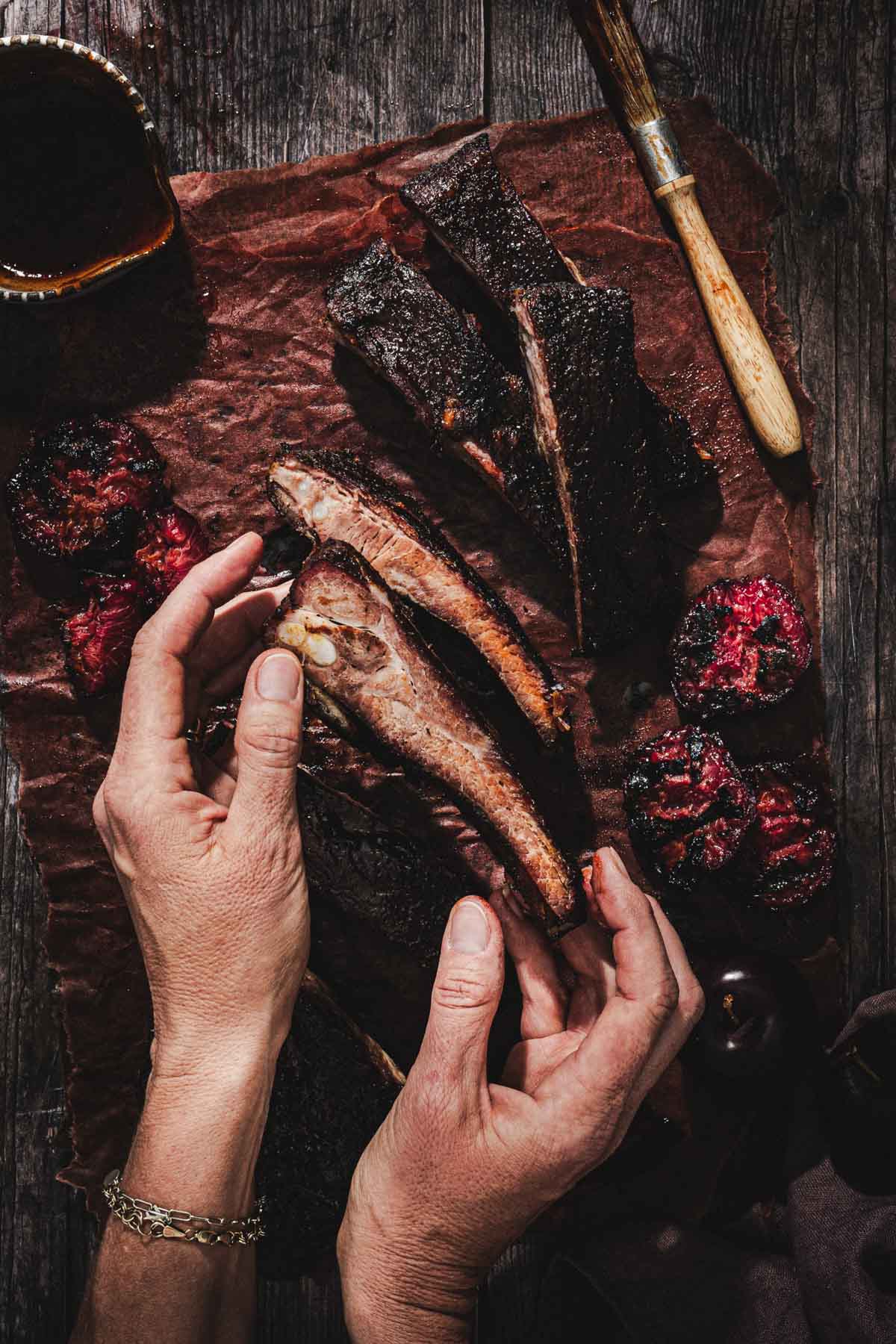 hands in frame holding a piece of the ribs