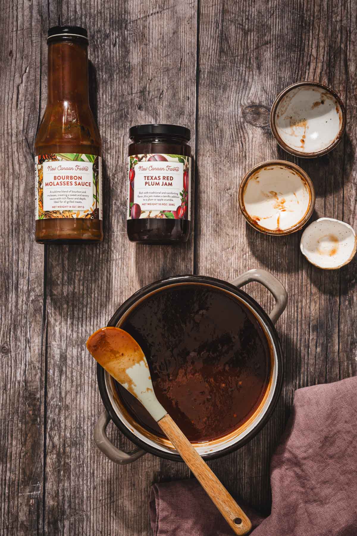 small saucepan with the made bbq glaze, brand jars