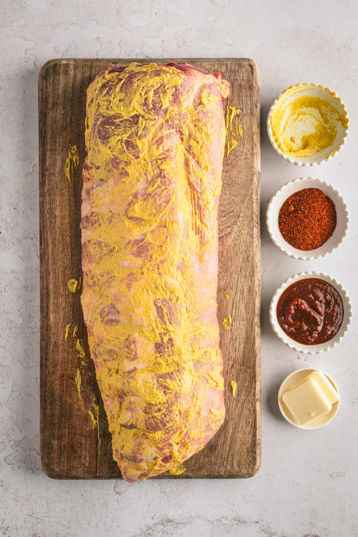 Raw pork ribs covered with mustard