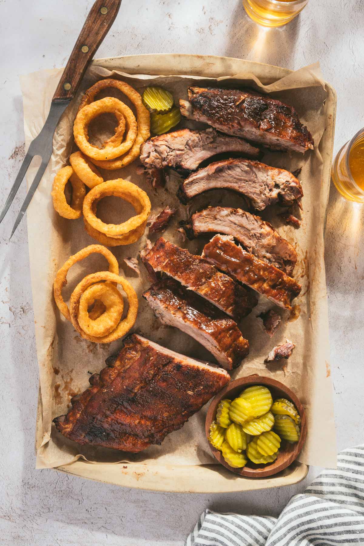 smoked ribs, cut into pieces, glass with beer, pickles