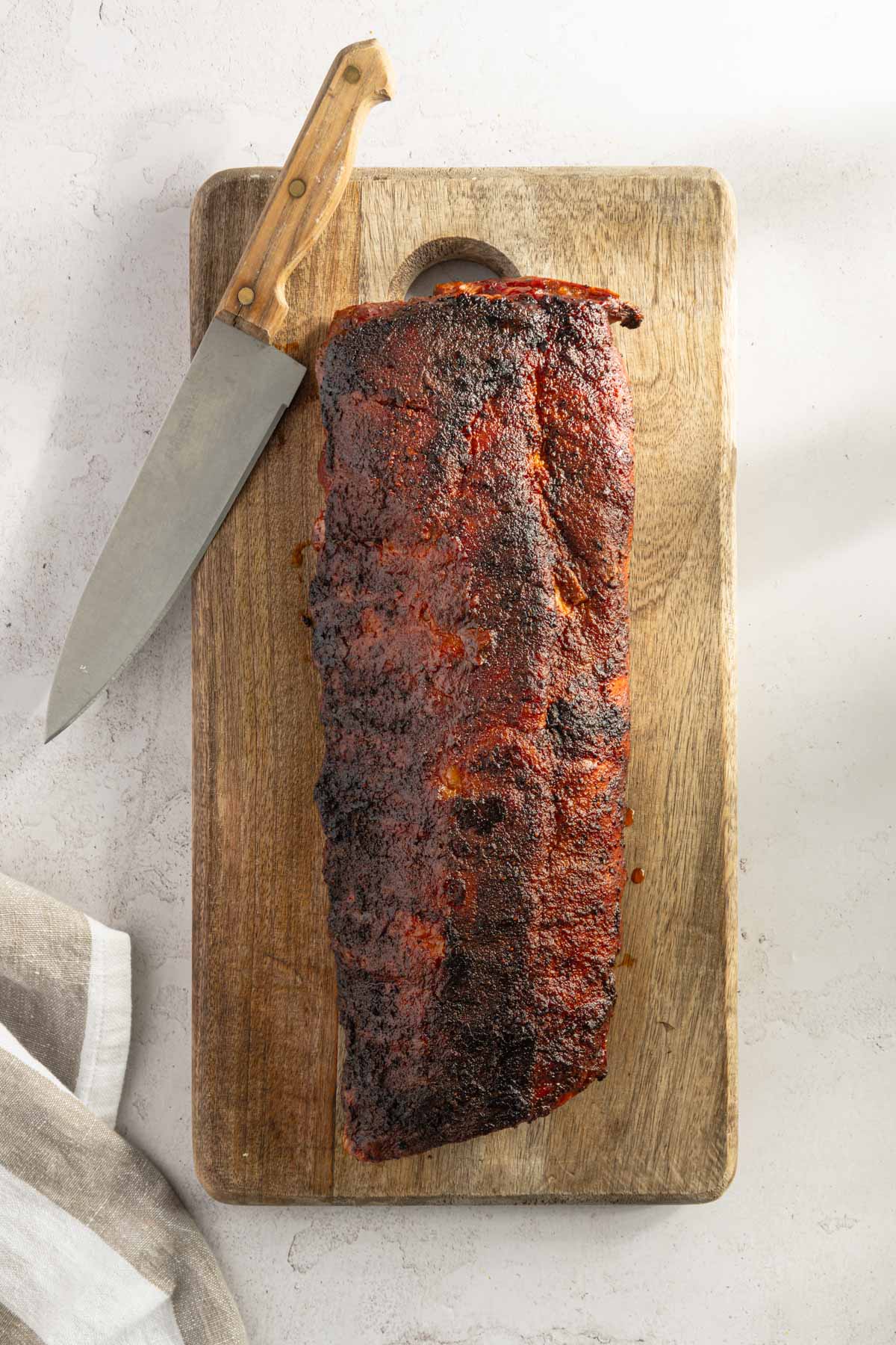 fully smoked pork ribs on a cutting board