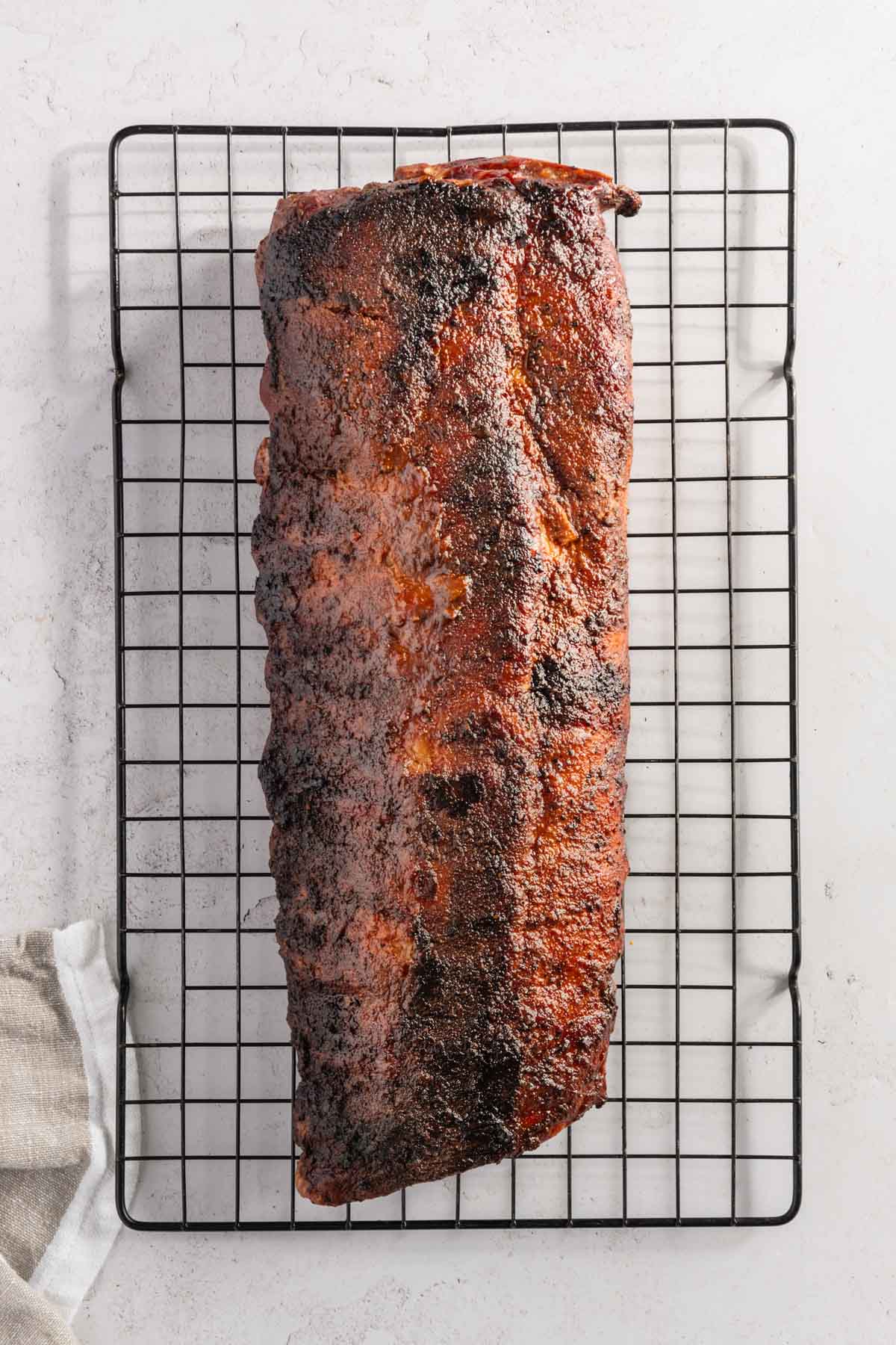 fully smoked pork ribs on a cooling rack