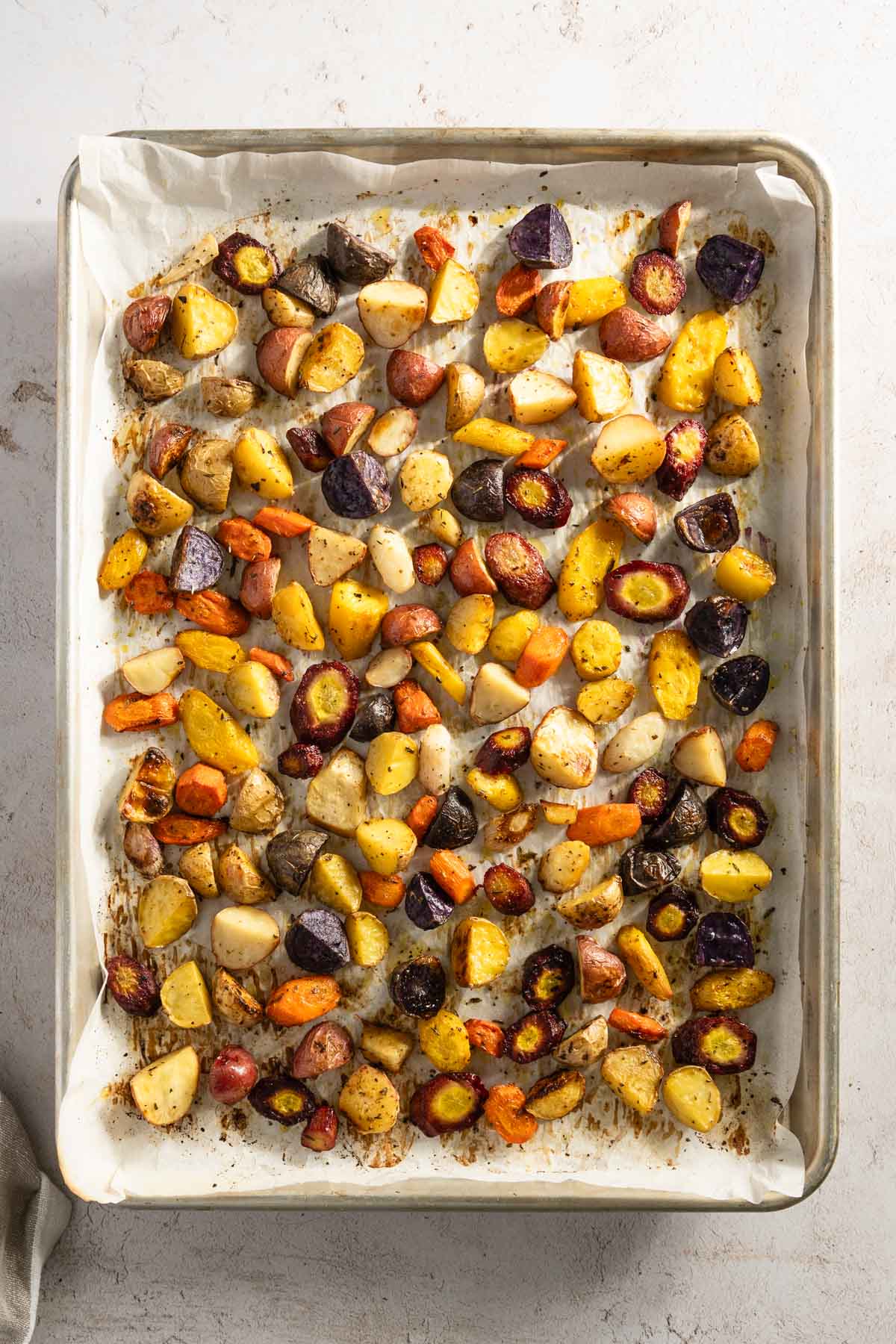 chopped and roasted veggies on a baking sheet