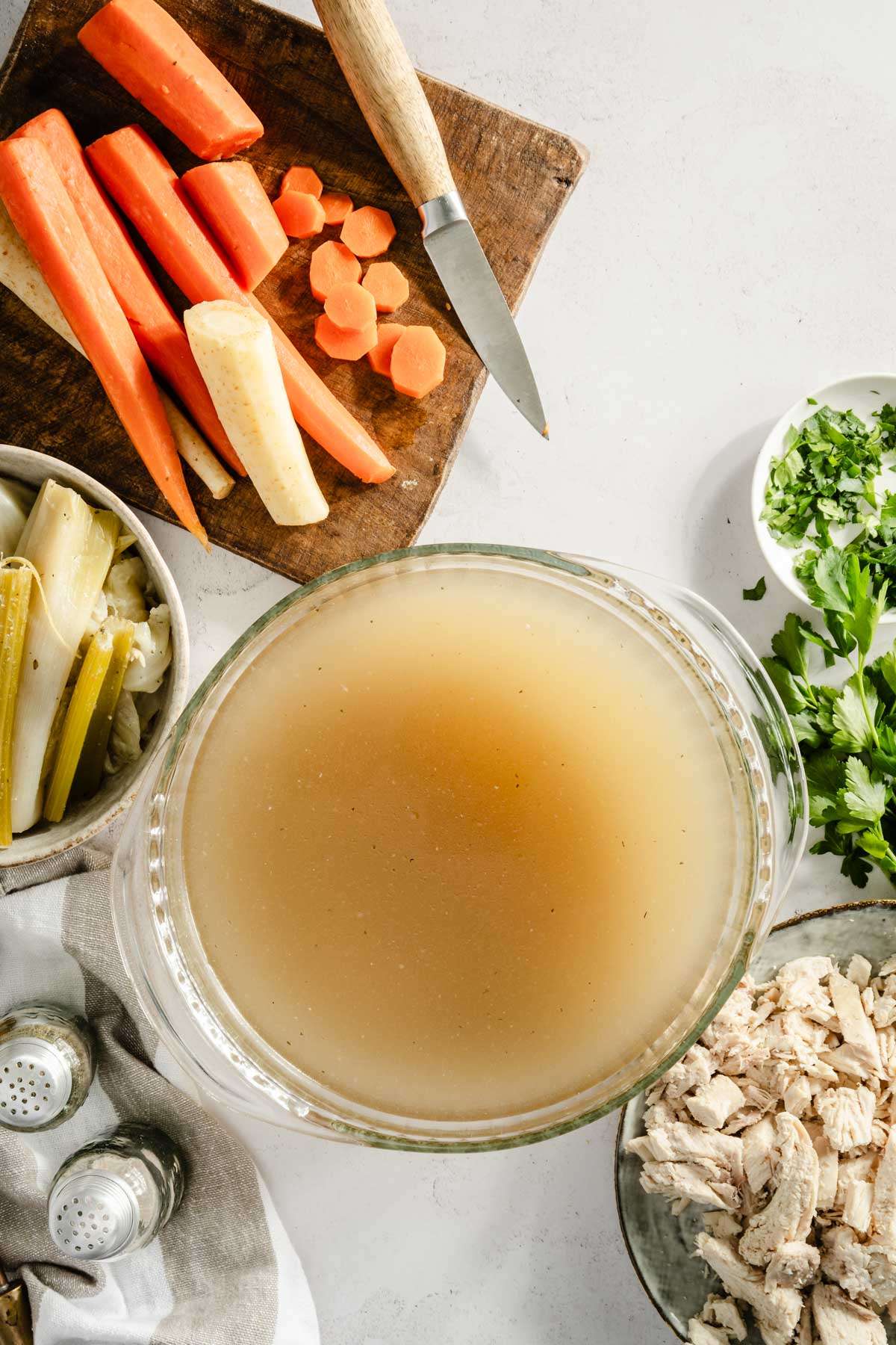 rosol in a glass dish, cooked veggies around