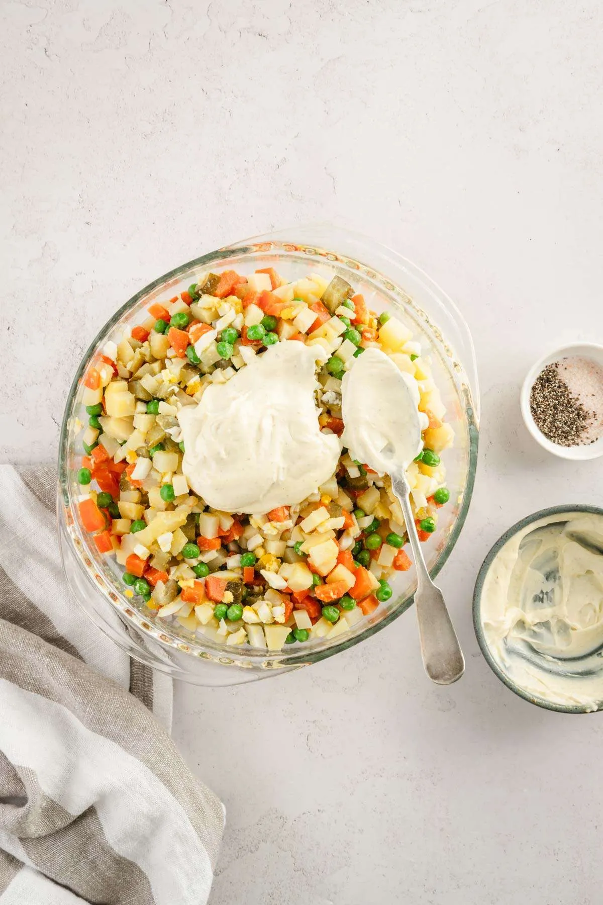 small dish with the dressing mixed in, bowl with the salad